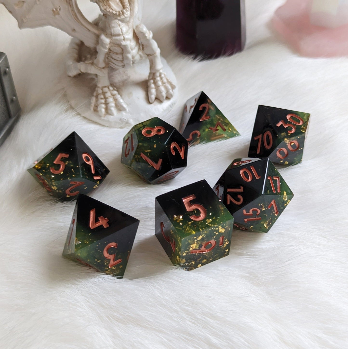 Dark green and black TTRPG dice set with copper numbers, featuring gold flakes and sharp edges, perfect for DnD gaming.