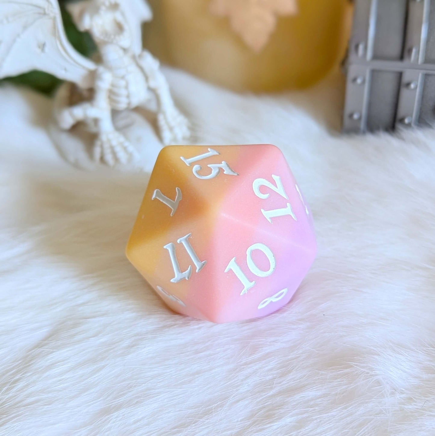 Sorbet Sunset Large D20 dice with matte ombre finish in pink, orange, and yellow hues, featuring white numbers on a fluffy surface.