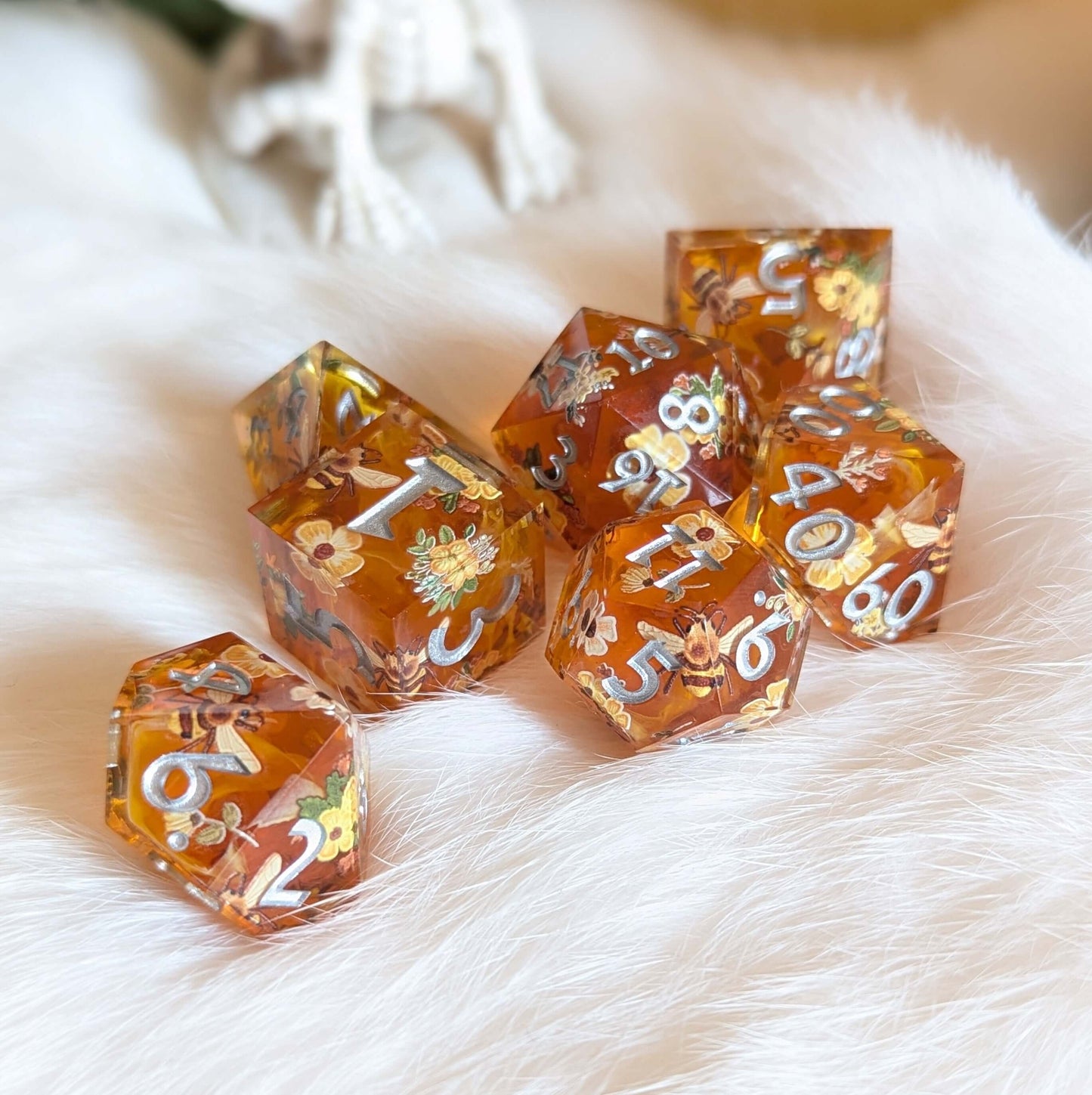 Honey Blossom sharp-edge dice set with bee and flower designs on plush white background.