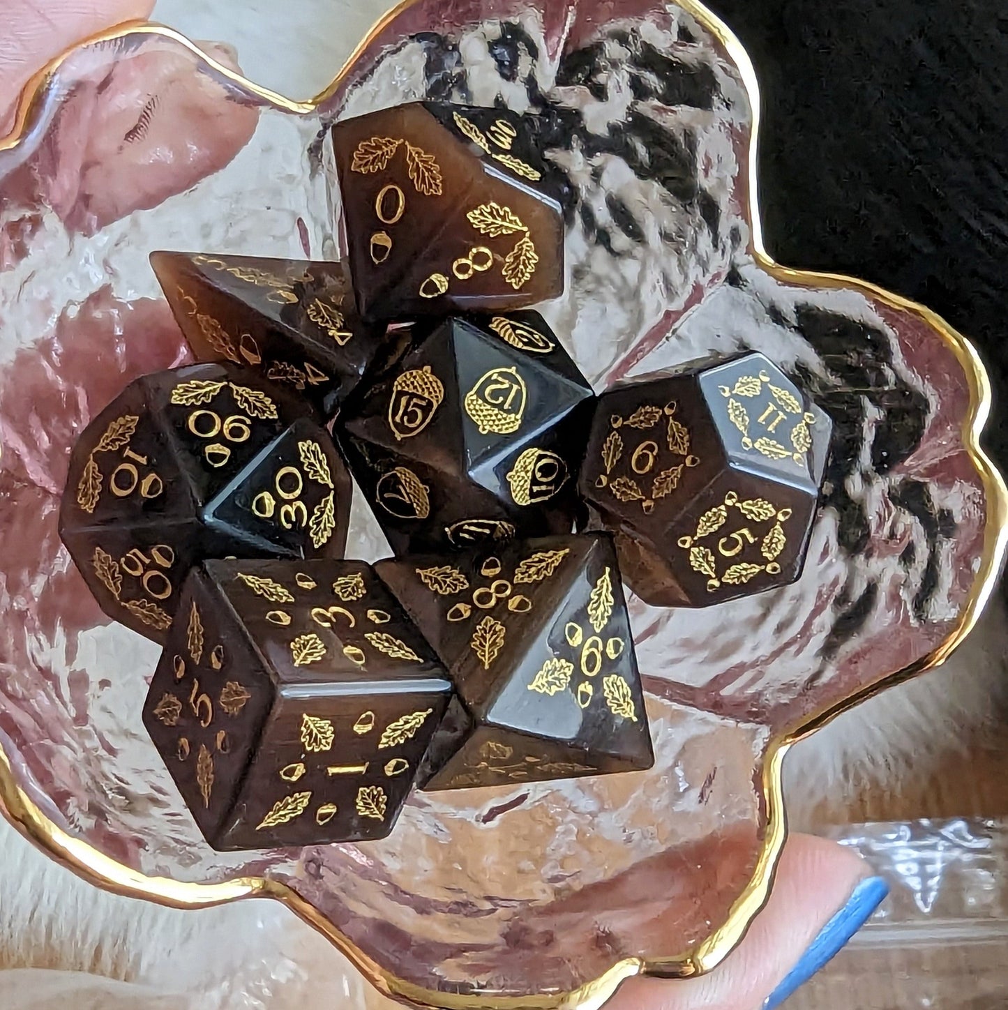 Acorn and Oak Dark Brown Cat's Eye Dice Set with golden leaf designs in a decorative bowl