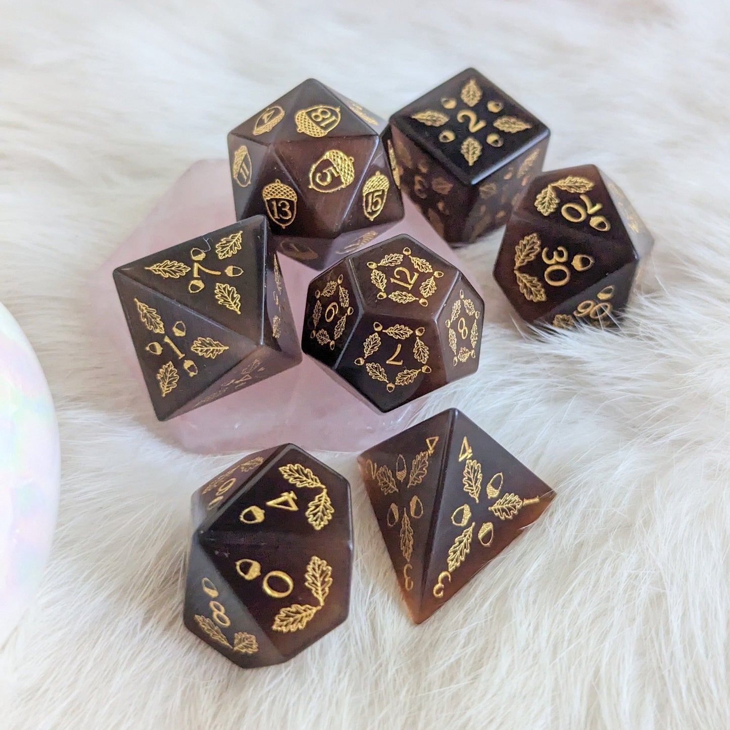 Acorn and Oak Dark Brown Cat's Eye Dice Set with engraved acorn and oak leaf designs, ideal for tabletop gaming.