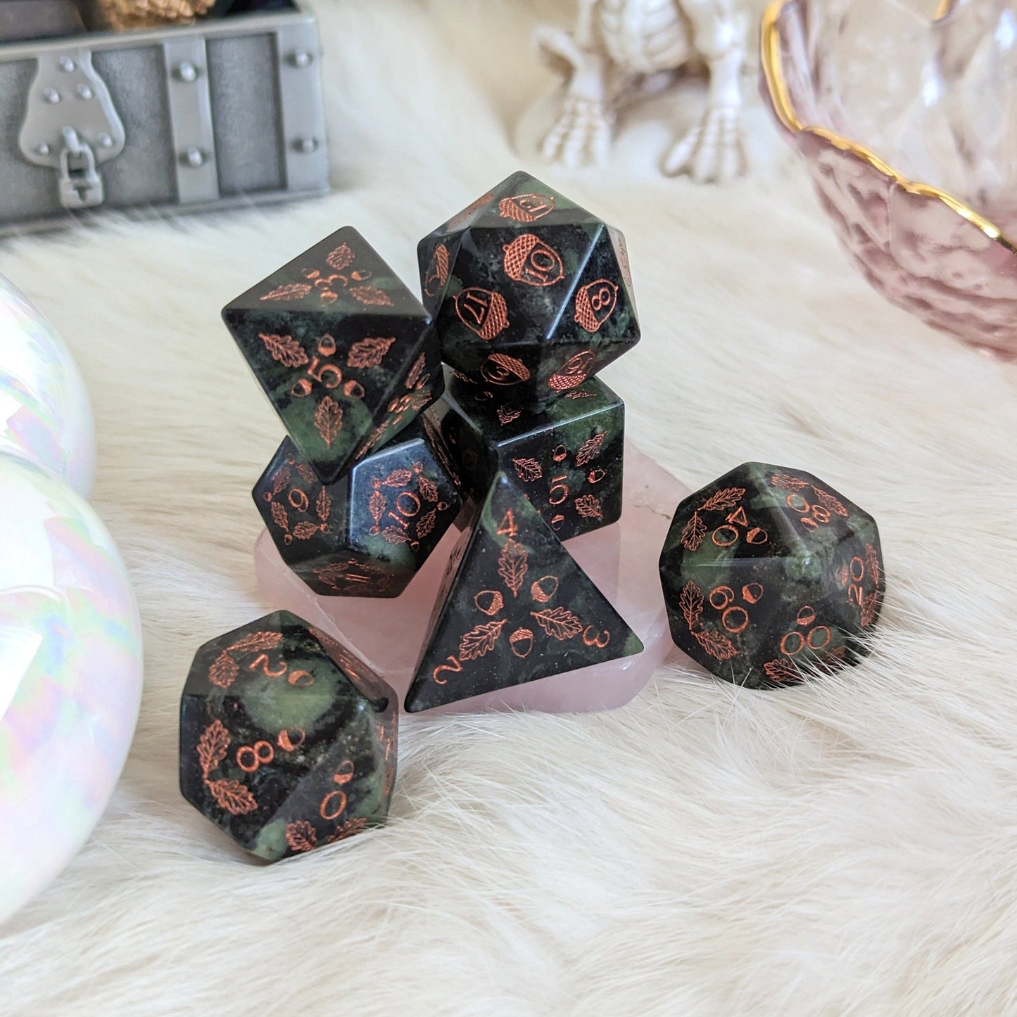 Acorn and Oak Jasper Gemstone Dice Set with intricate designs, perfect for druids, displayed on soft fabric background.