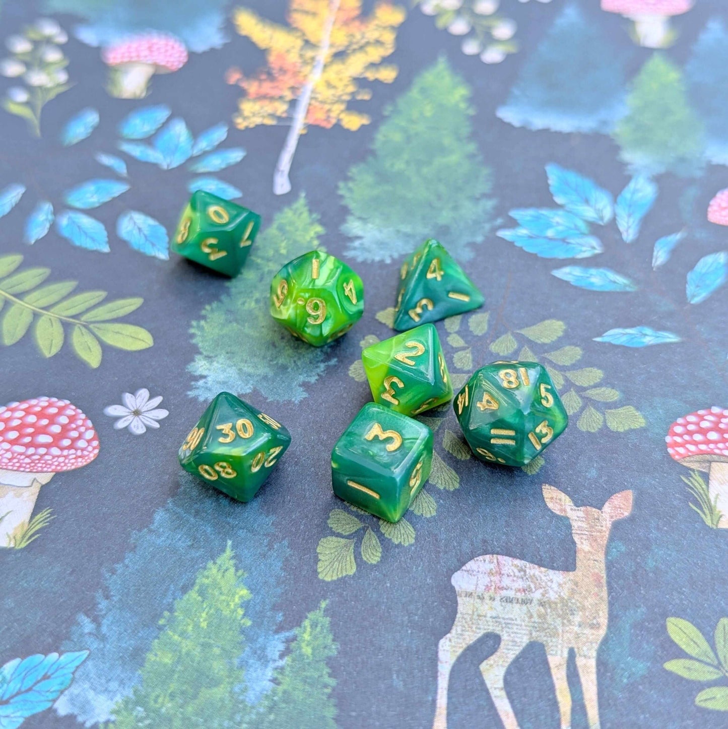 Pearly green Archer's Mini Dice Set with gold font on colorful background for tabletop RPGs like Dungeons & Dragons.