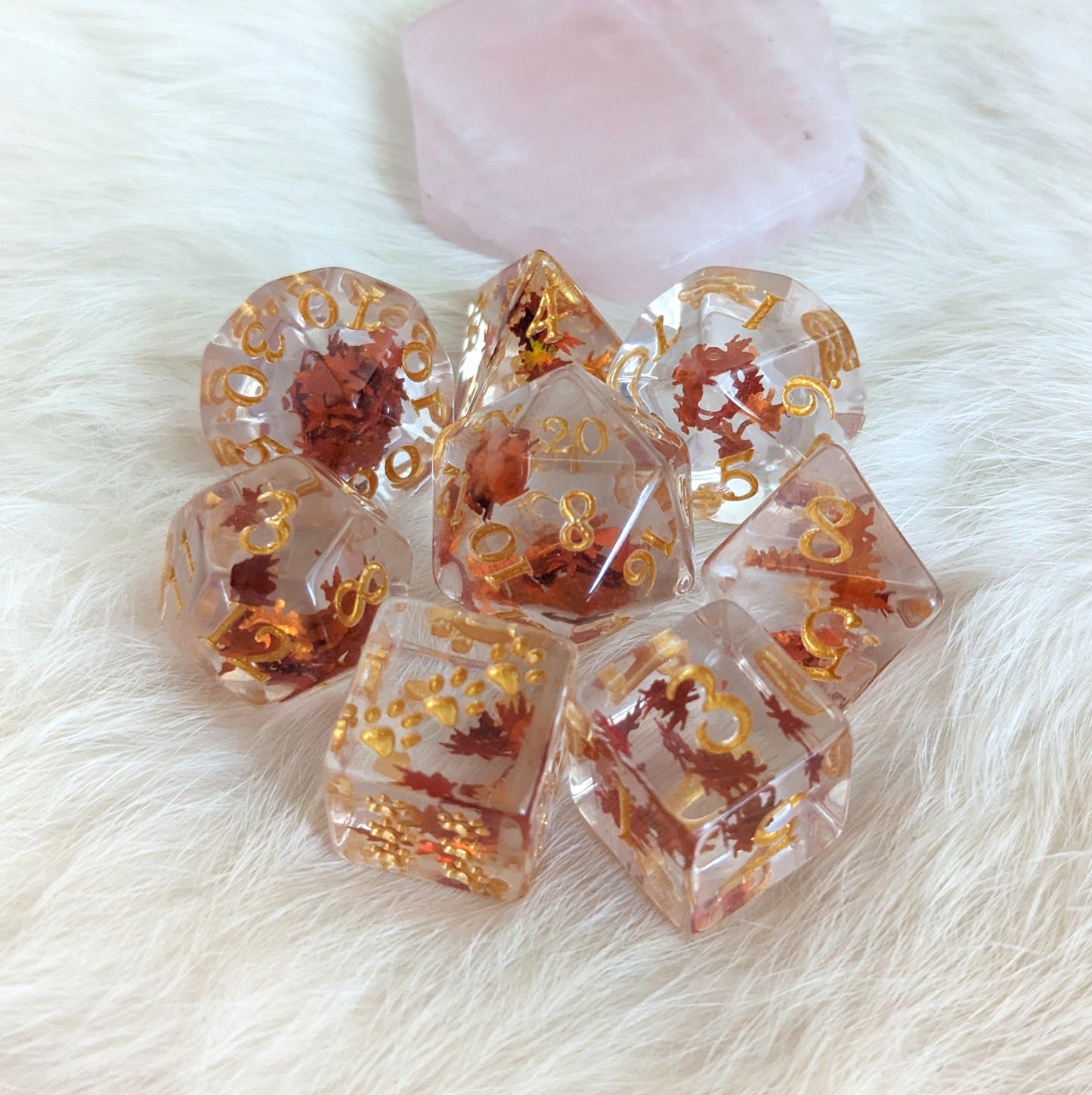 Autumn Leaf Dice Set with orange leaf glitter, 8 piece TTRPG dice for Dungeons and Dragons, on a soft fur background.