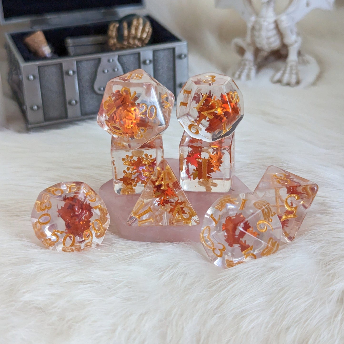 Autumn Leaf Dice Set with orange leaf glitter on display, featuring 8 pieces including a paw-marked D6 for tabletop RPGs.