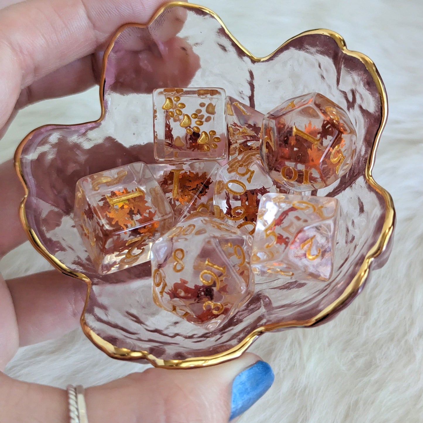 Autumn Leaf Dice Set with orange leaf glitter in a flower-shaped bowl, perfect for Dungeons and Dragons and TTRPGs.