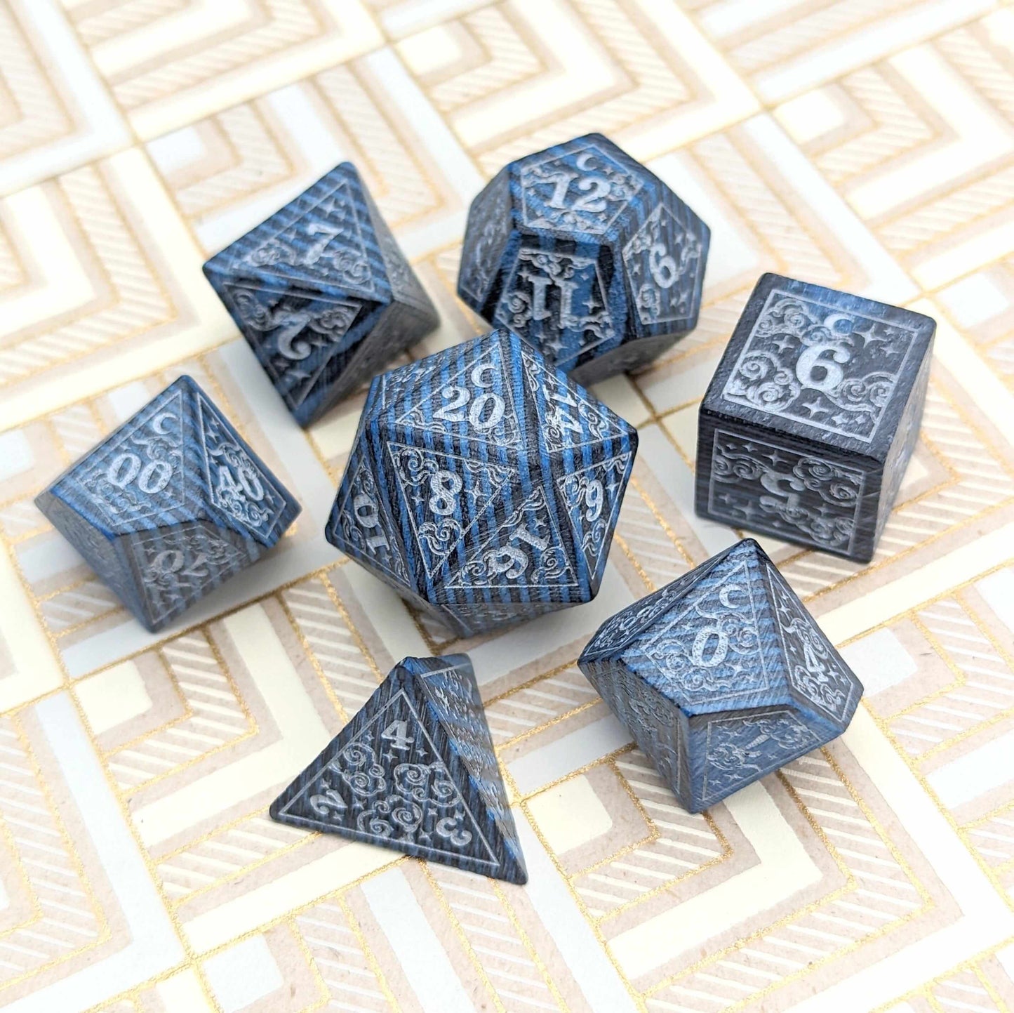 Blue Dreamy Star and Moon Wood Dice Set on patterned surface for DnD gaming sessions.