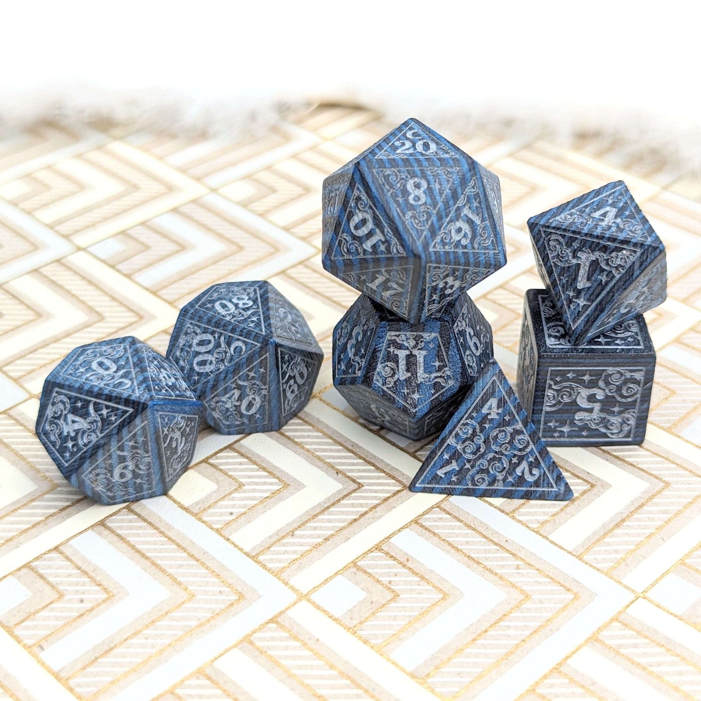 Blue dreamy star and moon wood dice set for Dungeons & Dragons on a patterned surface.