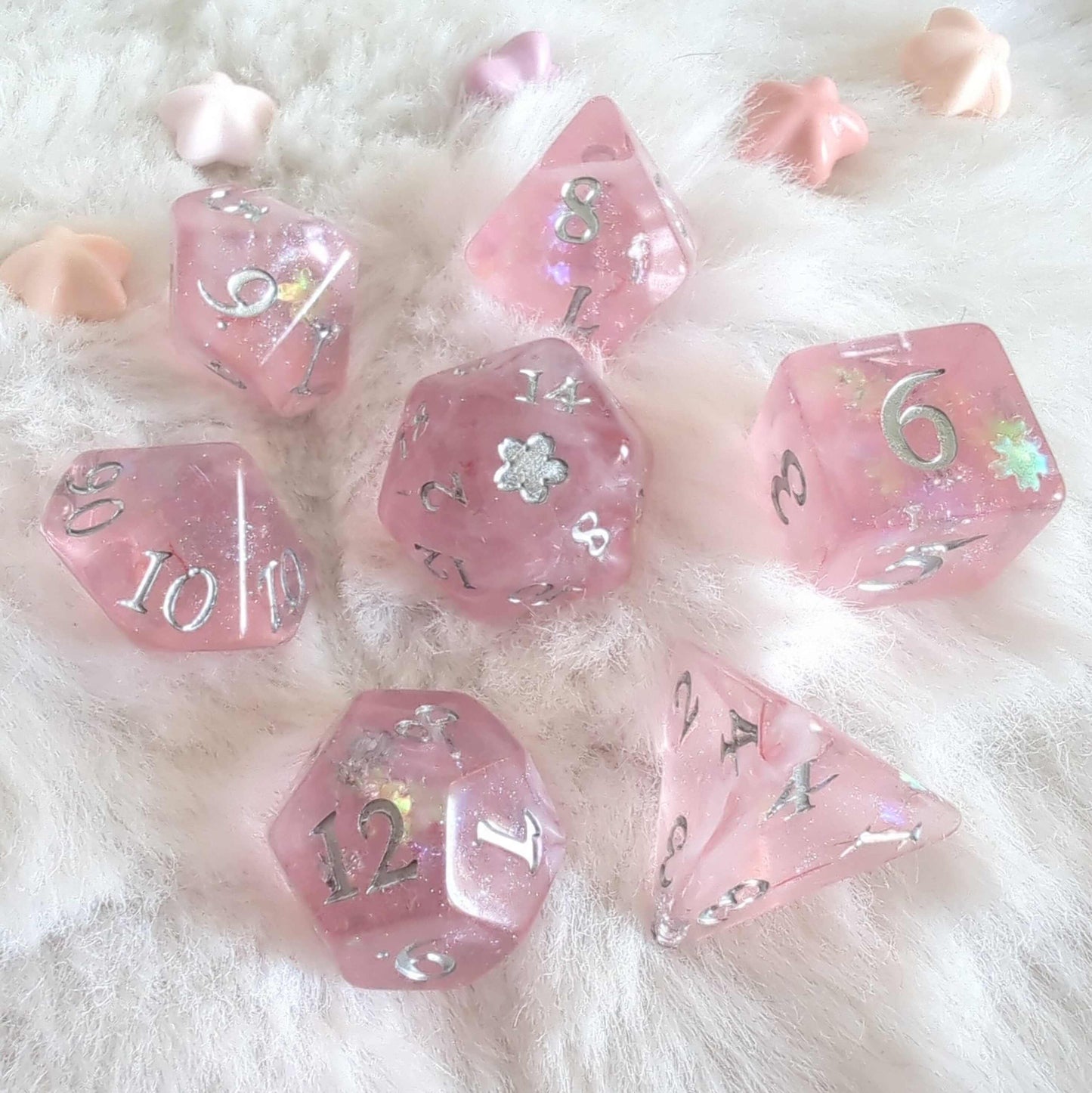 Cherry Blossom Dice Set with pink, glittery design and silver numbers on a fluffy white background.
