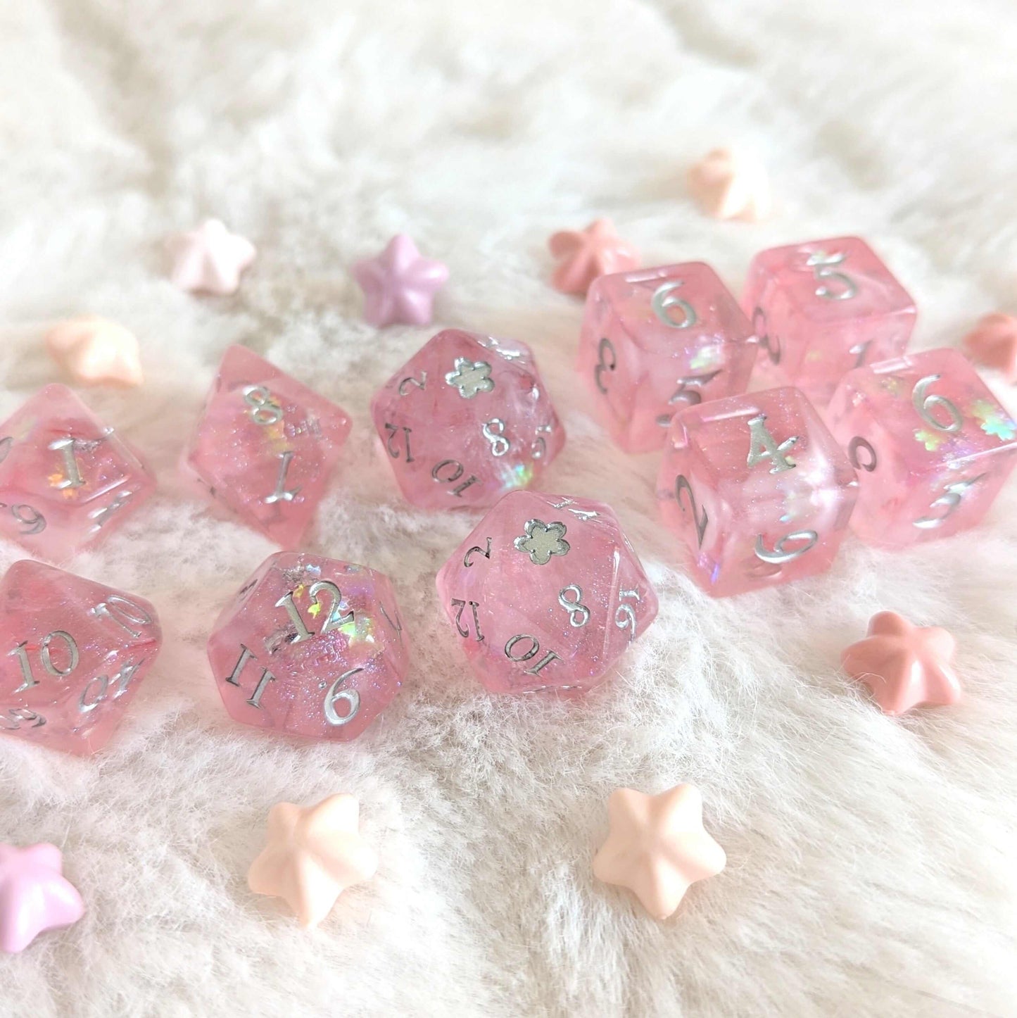 Cherry Blossom Dice Set with pink hue, silver numerals, and cherry blossom glitter detail on white surface.