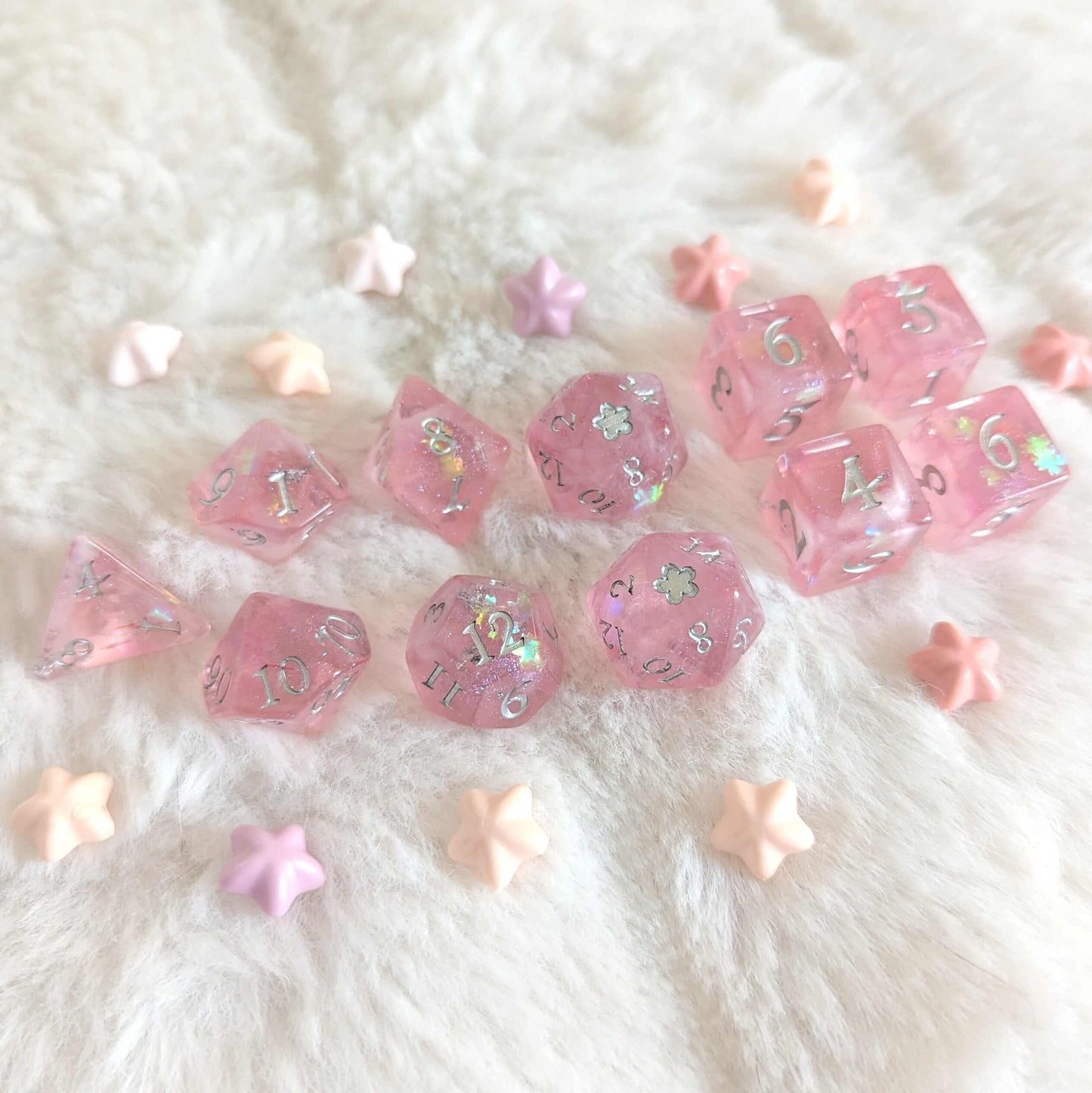 Cherry Blossom Dice Set featuring light pink dice with silver numbers and cherry blossom glitter on a soft, textured surface.