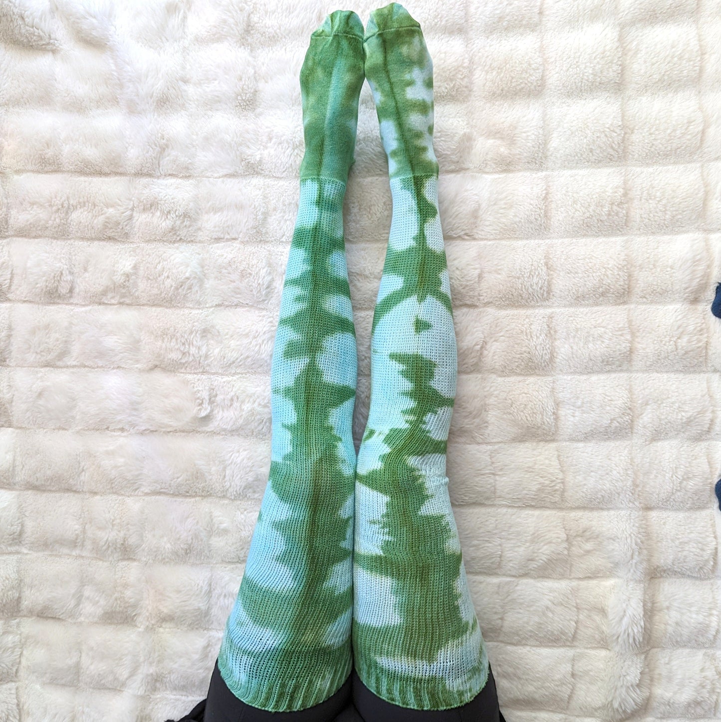 Cozy Sea Elf blue green tie-dyed thigh high cotton socks on soft textured background.