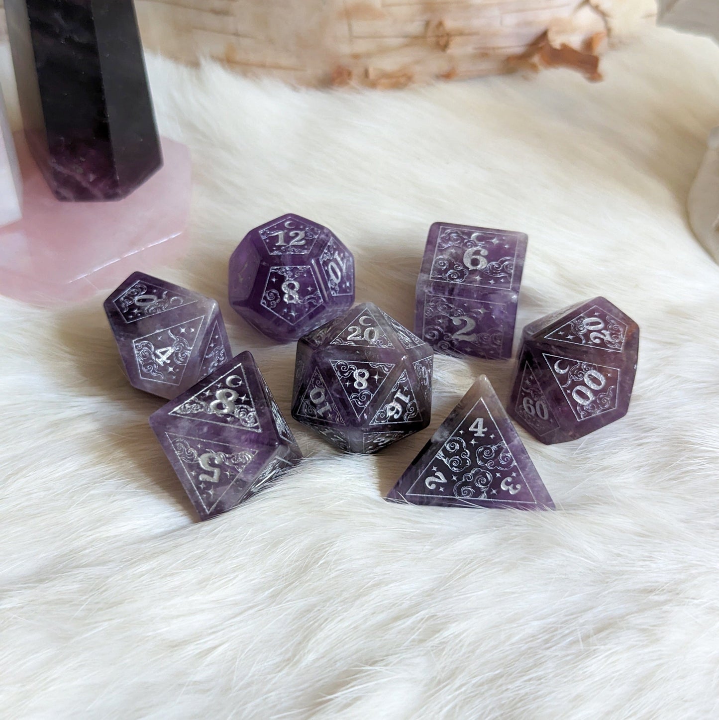 Dreamy Amethyst Dice Set with clouds, moons, and star designs etched in silver, perfect for Dungeons & Dragons gameplay.