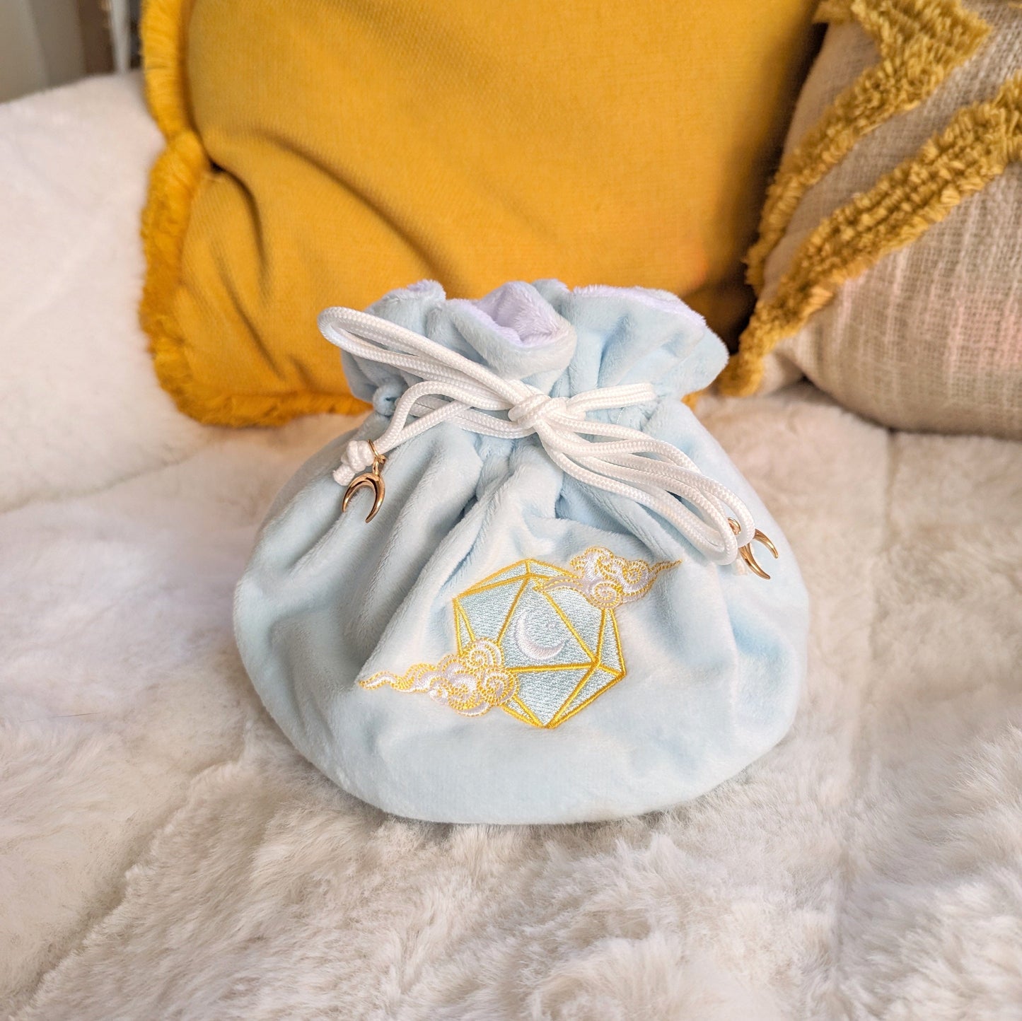 Large blue dice bag with multi pockets, embroidered D20 design, crescent moon, star, and gold crescent beads on drawstrings.