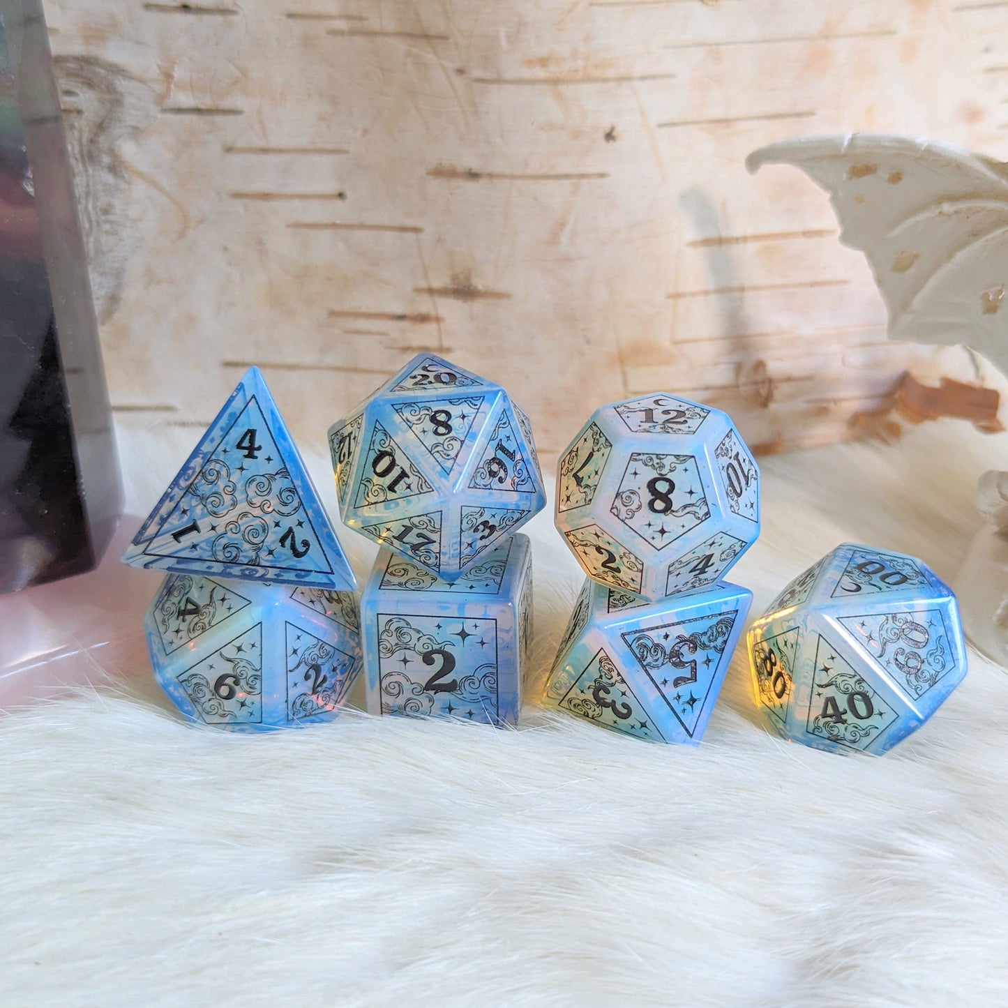 Dreamy Opalite Dice Set featuring clouds, moons, and black star designs for magical Dungeons & Dragons gameplay.