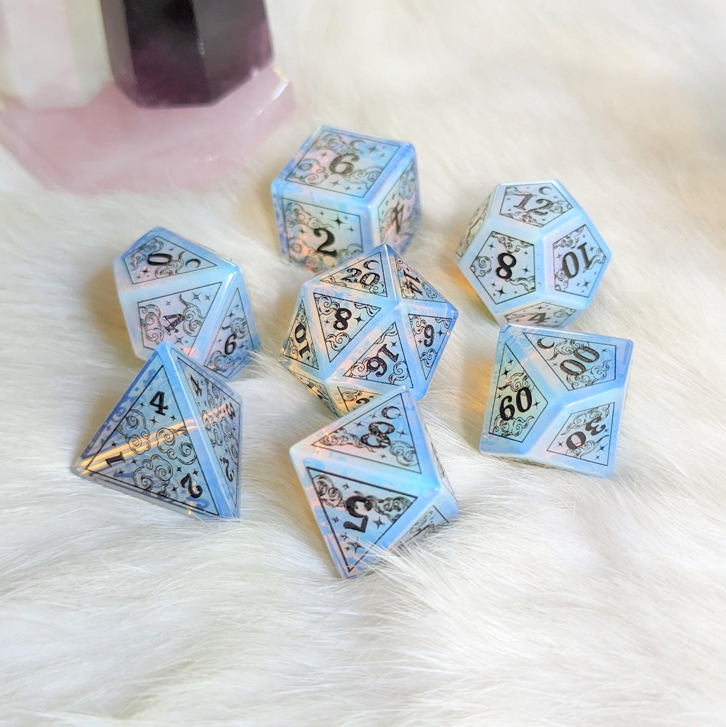 Dreamy Opalite Dice Set with black font, featuring clouds, stars, and crescent moons, perfect for enhancing Dungeons & Dragons gameplay.