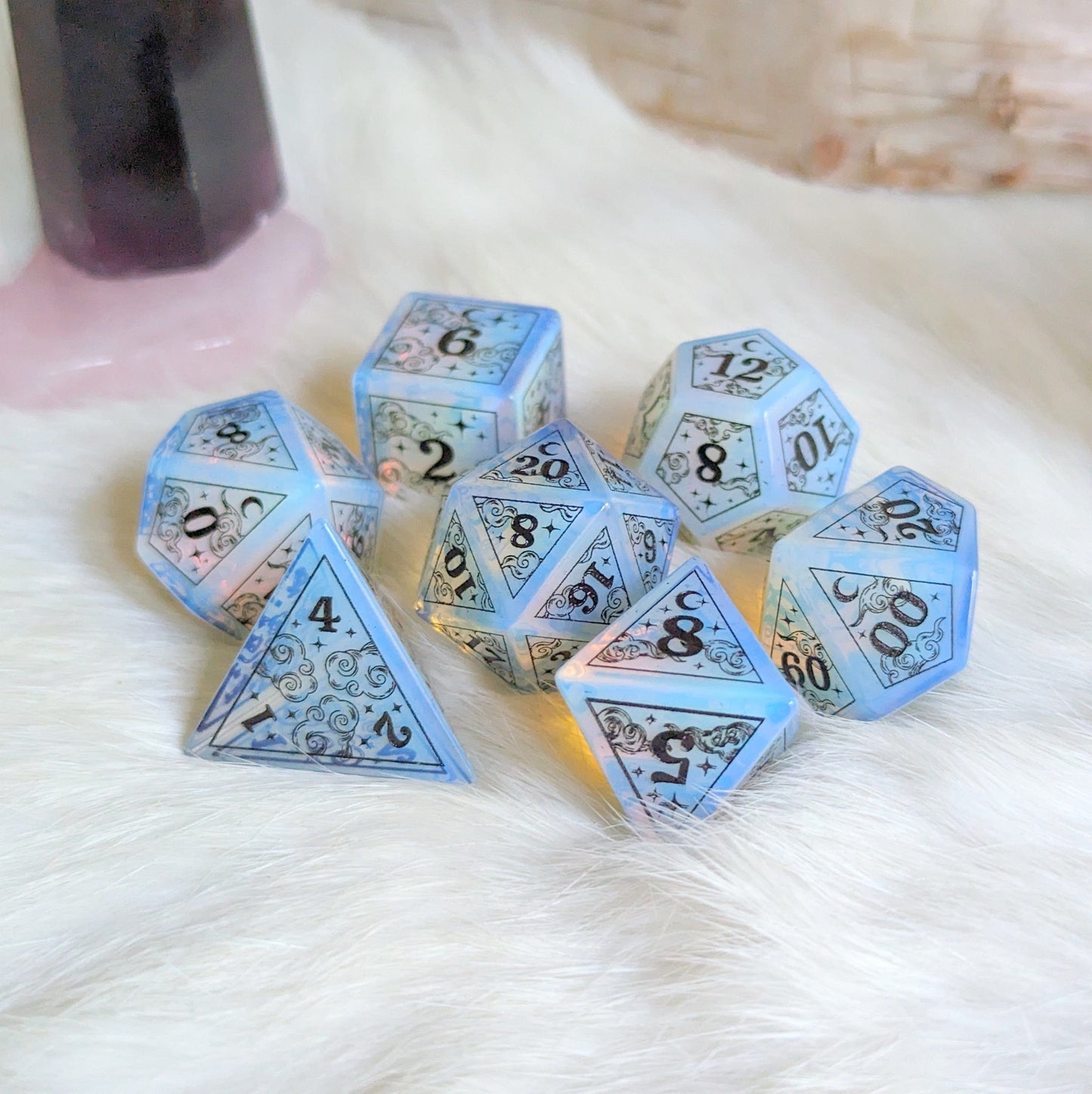 Dreamy Opalite Dice Set with black font, featuring cloud and star designs, perfect for Dungeons & Dragons gaming magic.
