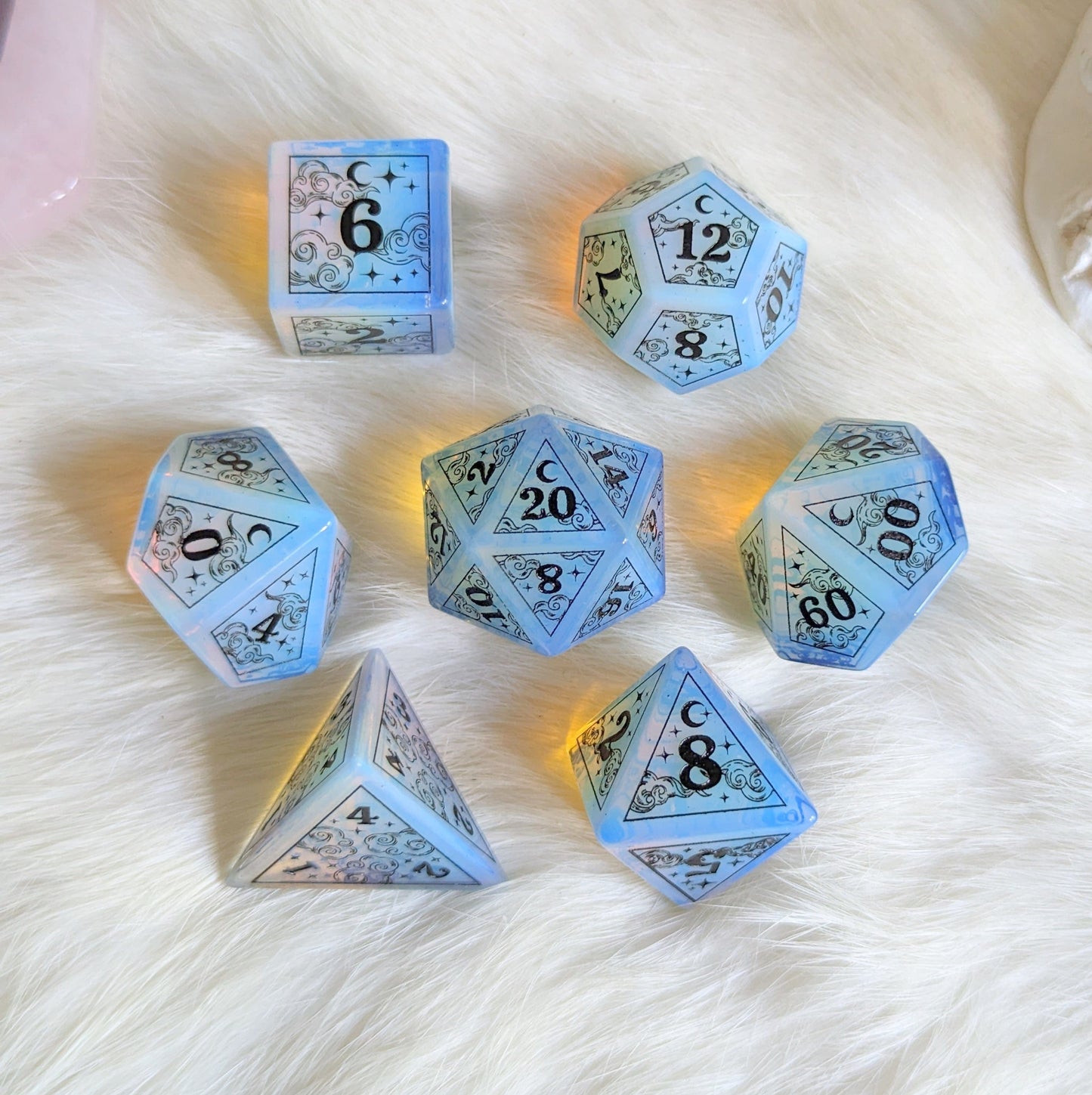 Dreamy Opalite Dice Set with black font featuring clouds, moons, and stars design, perfect for Dungeons & Dragons gaming.
