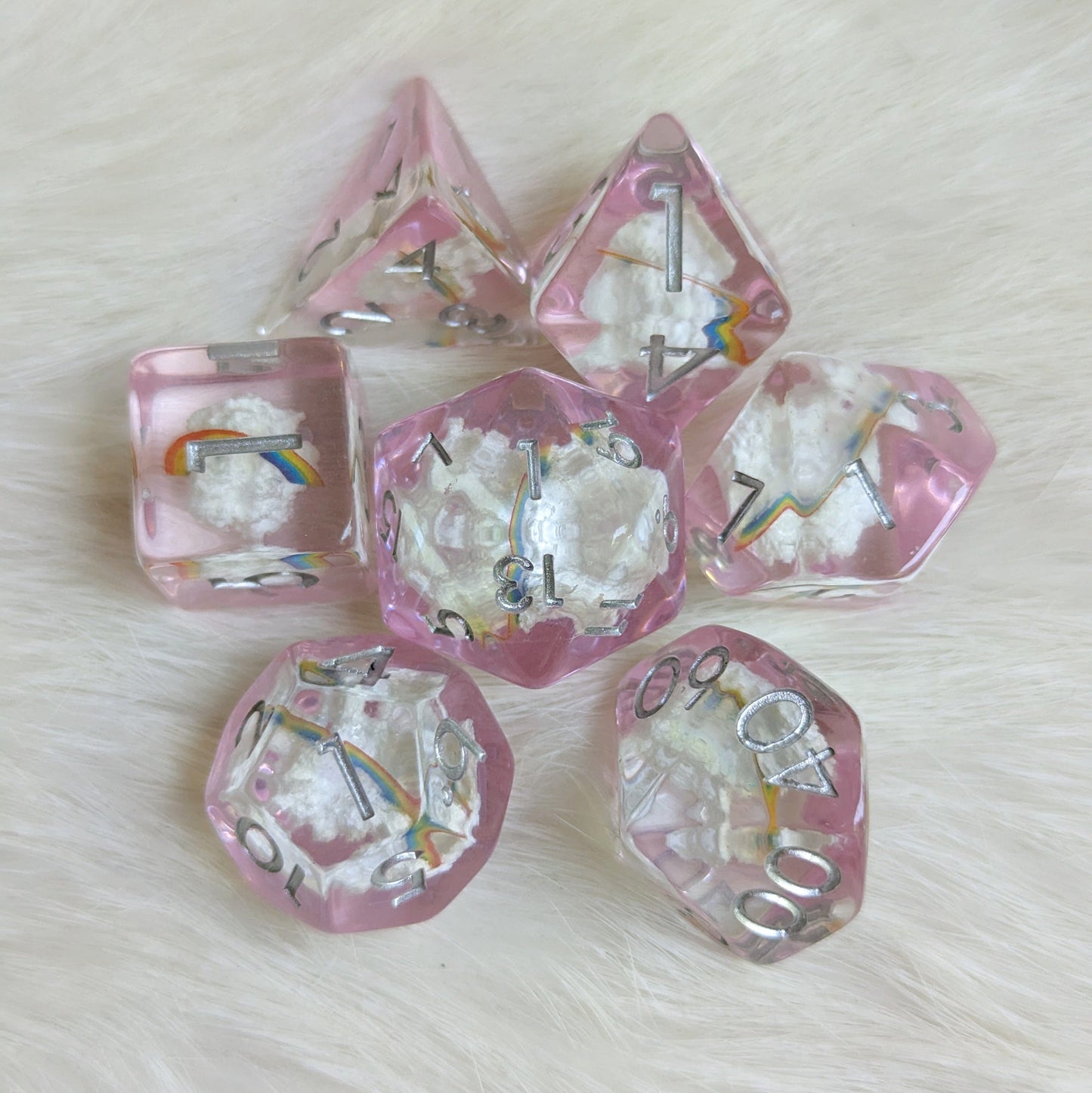 Dreamy Rainbows and Clouds Dice Set with realistic clouds and rainbows in clear resin, designed by Therin of Fennek and Finch.