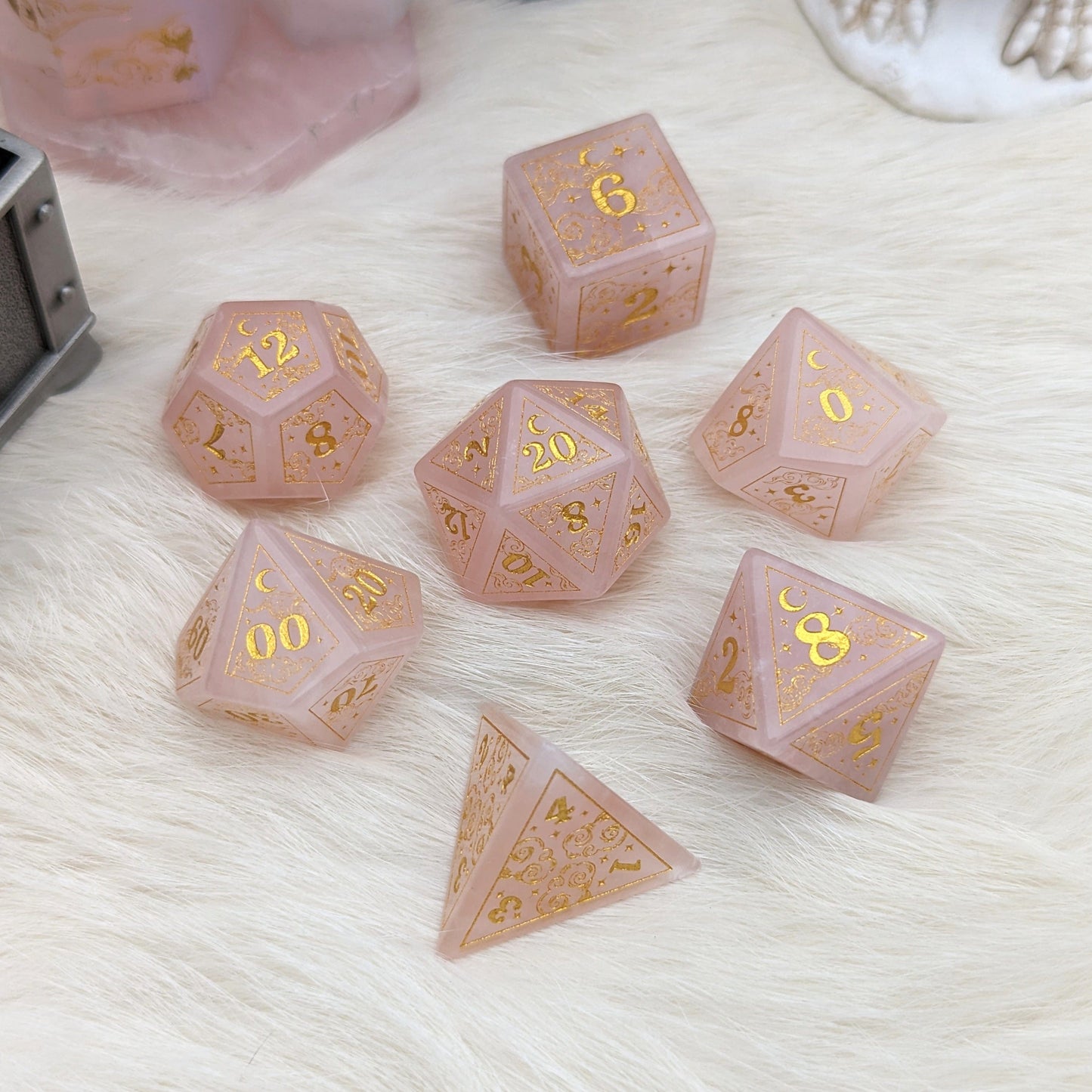 Dreamy Rose Quartz Dice Set with gold-etched clouds, moons, and stars on soft pink gemstone, perfect for Dungeons & Dragons.