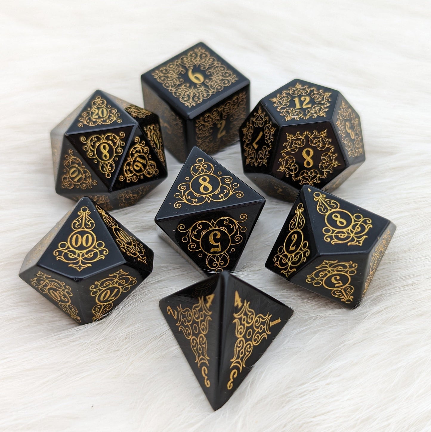 Garden Gate Obsidian Gemstone Dice Set with intricate flower and swirl designs, crafted from volcanic obsidian.