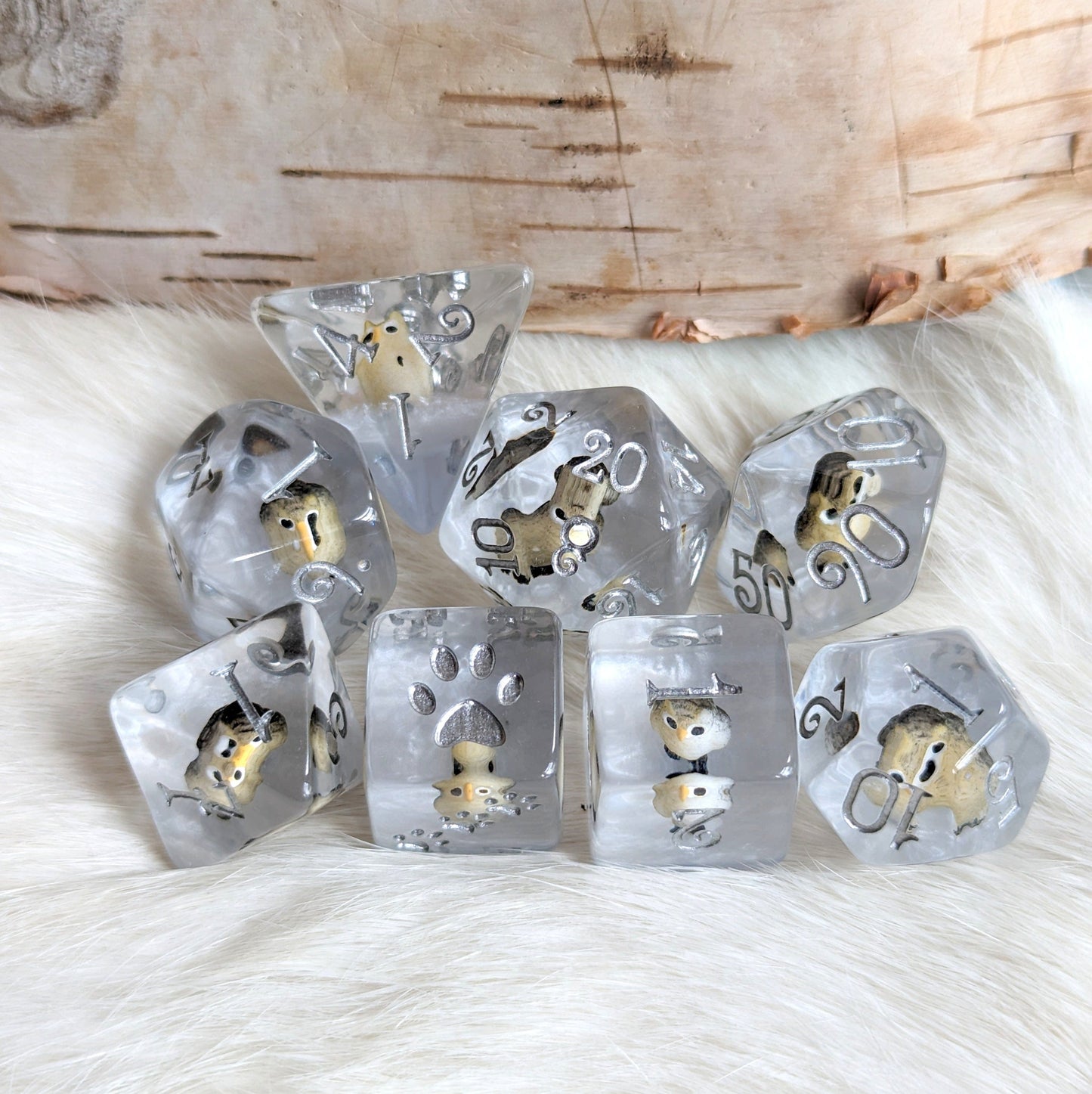 Horned Owl Dice Set featuring miniature owls in clear resin with silver and blue accents, 8 piece polyhedral TTRPG dice set.