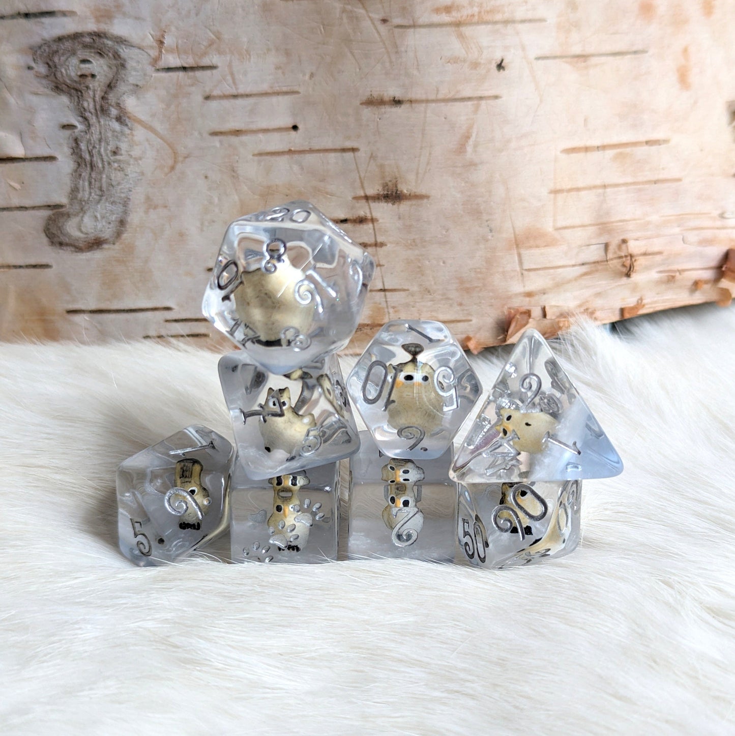 Horned Owl Dice Set with miniature owls in clear resin, featuring silver and blue details, for TTRPGs and Magic games.