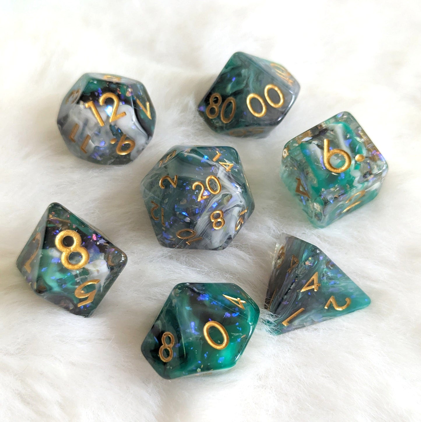 Hunter's Mark Dice Set featuring green, black, and white glitter resin with gold numbers for tabletop RPGs like Dungeons and Dragons.