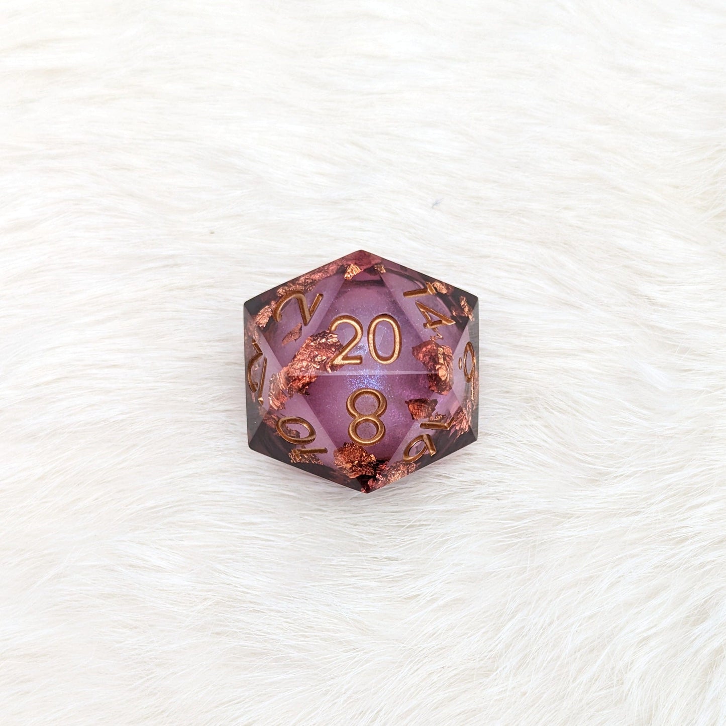Large liquid core D20 die with swirling glitter, ideal for Dungeons and Dragons, on a white surface.