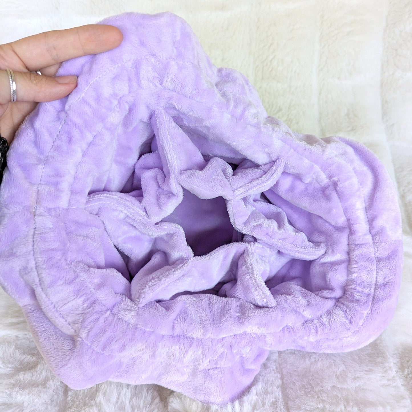 Inner view of lavender multi-pocket dice bag with soft plush fabric and spacious compartments for organizing gaming dice.