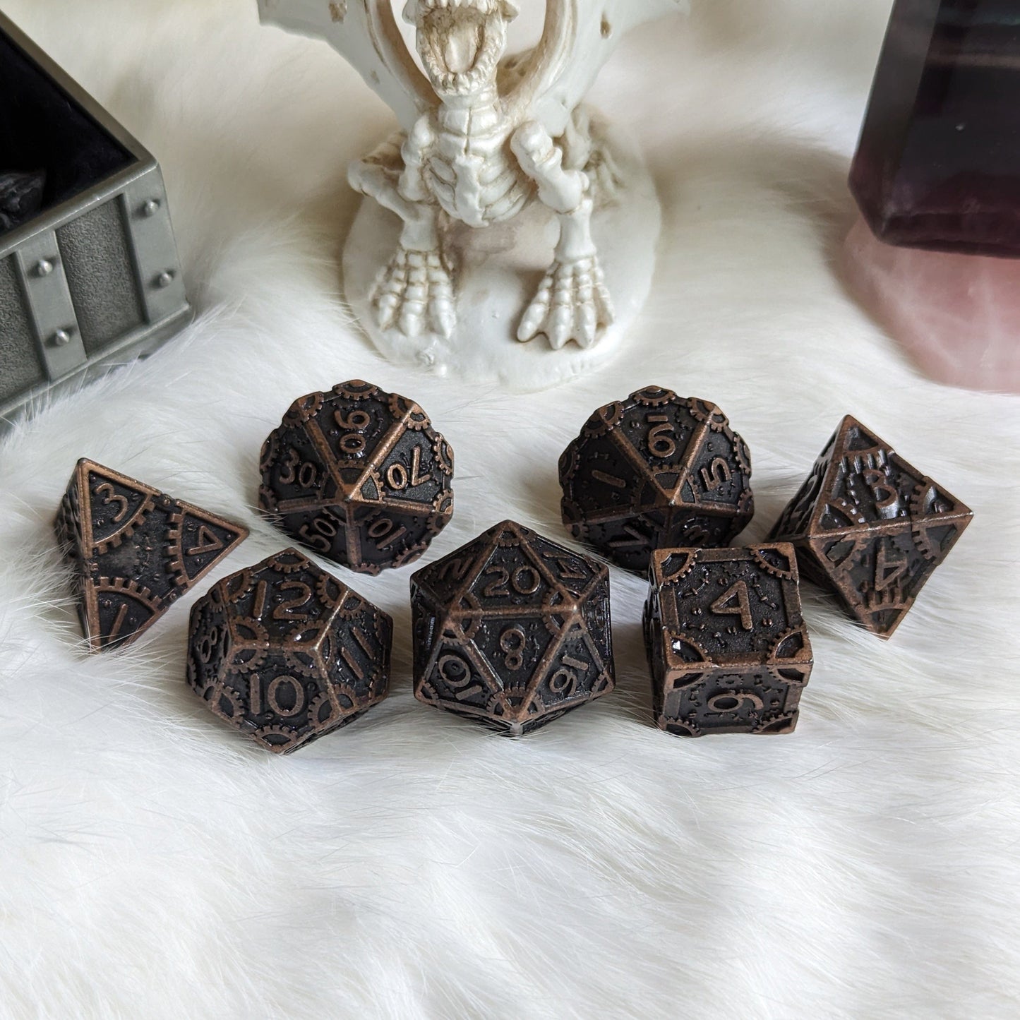 Bronze Metal Gears Dice Set with clockwork design and seven polyhedral dice for tabletop RPGs like Dungeons and Dragons.