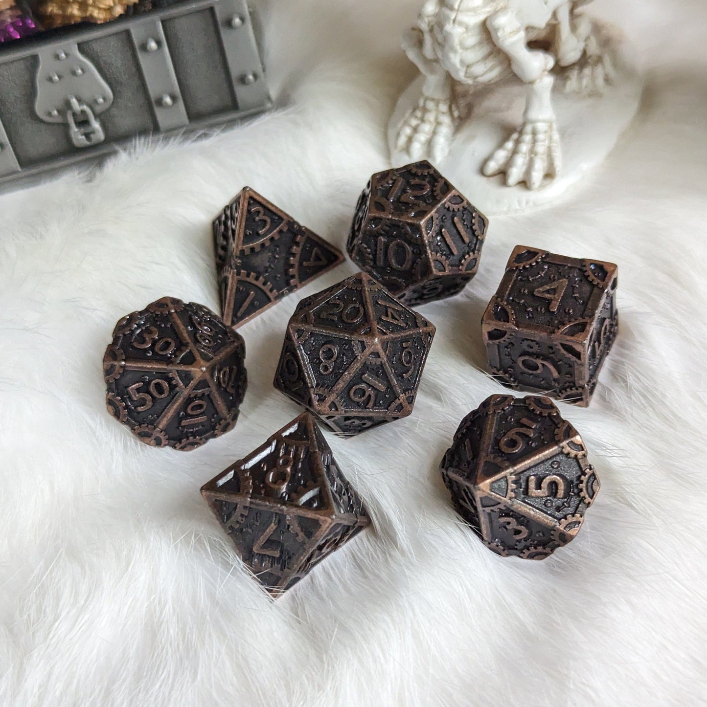 Bronze Metal Gears Dice Set, featuring seven polyhedral dice with clockwork design for tabletop RPGs, displayed on a white surface.