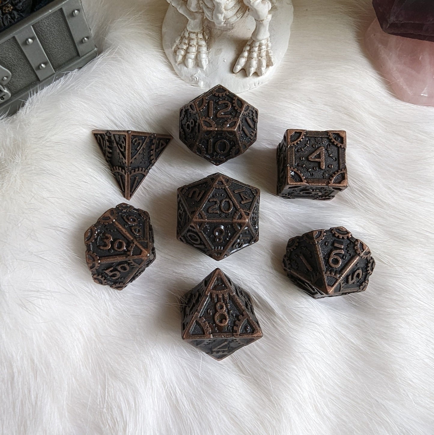 Bronze Metal Gears Dice Set with clockwork design for tabletop RPGs on a white furry surface.