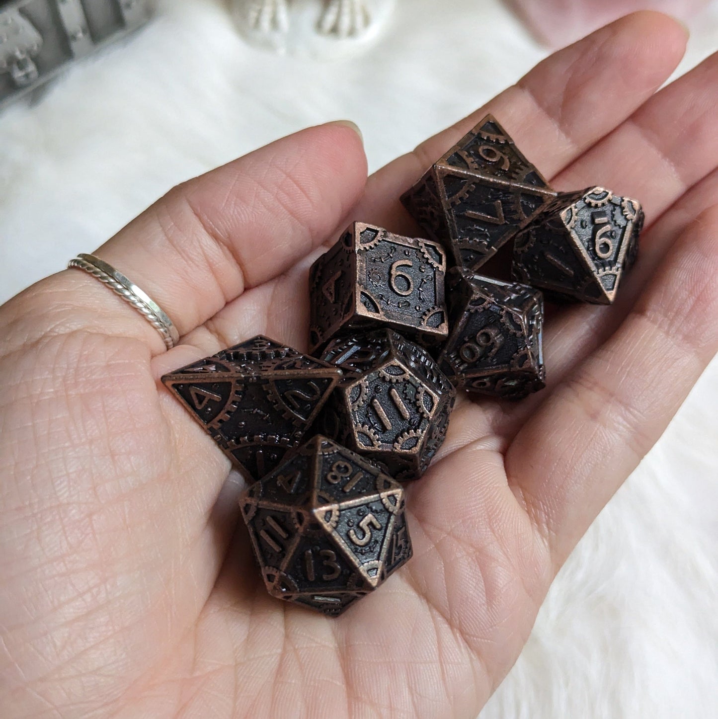 Bronze Metal Gears Dice Set with clockwork design, featuring seven polyhedral dice for tabletop RPGs like Dungeons and Dragons.