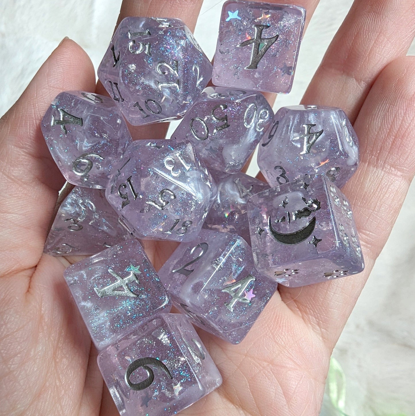 Moonbeam Dice Set with light purple hue, star glitter, silver numbers, crescent moon design, and wispy clouds, for TTRPG games.
