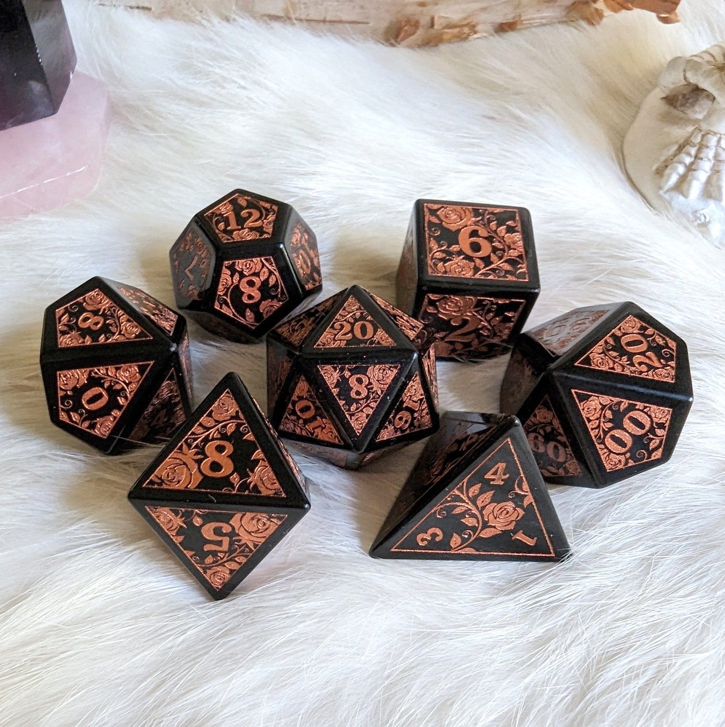Obsidian Rose Dice Set with copper rose and vine engravings on volcanic glass, perfect for Dungeons & Dragons.