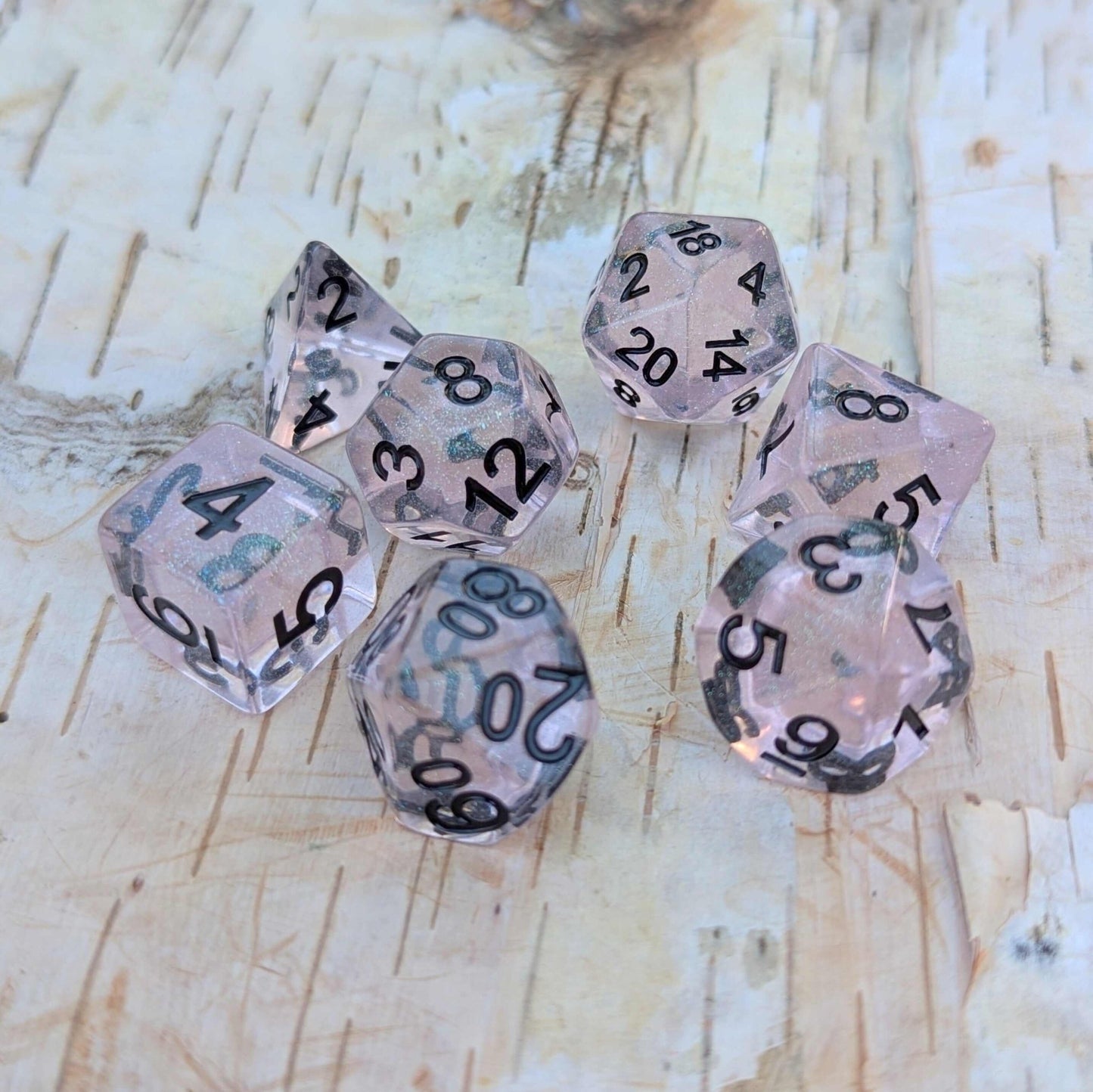 Pink Stardust Dice Set – 7 - Piece Clear Pink Iridescent Glitter Black Font DnD - Fennek and Finch