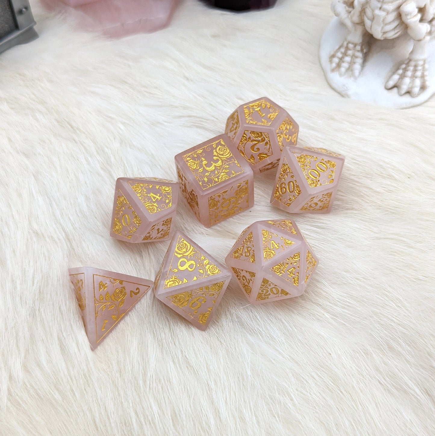 Quartz of Roses Dice Set with gold rose and vine designs on rose quartz, perfect for Dungeons & Dragons.