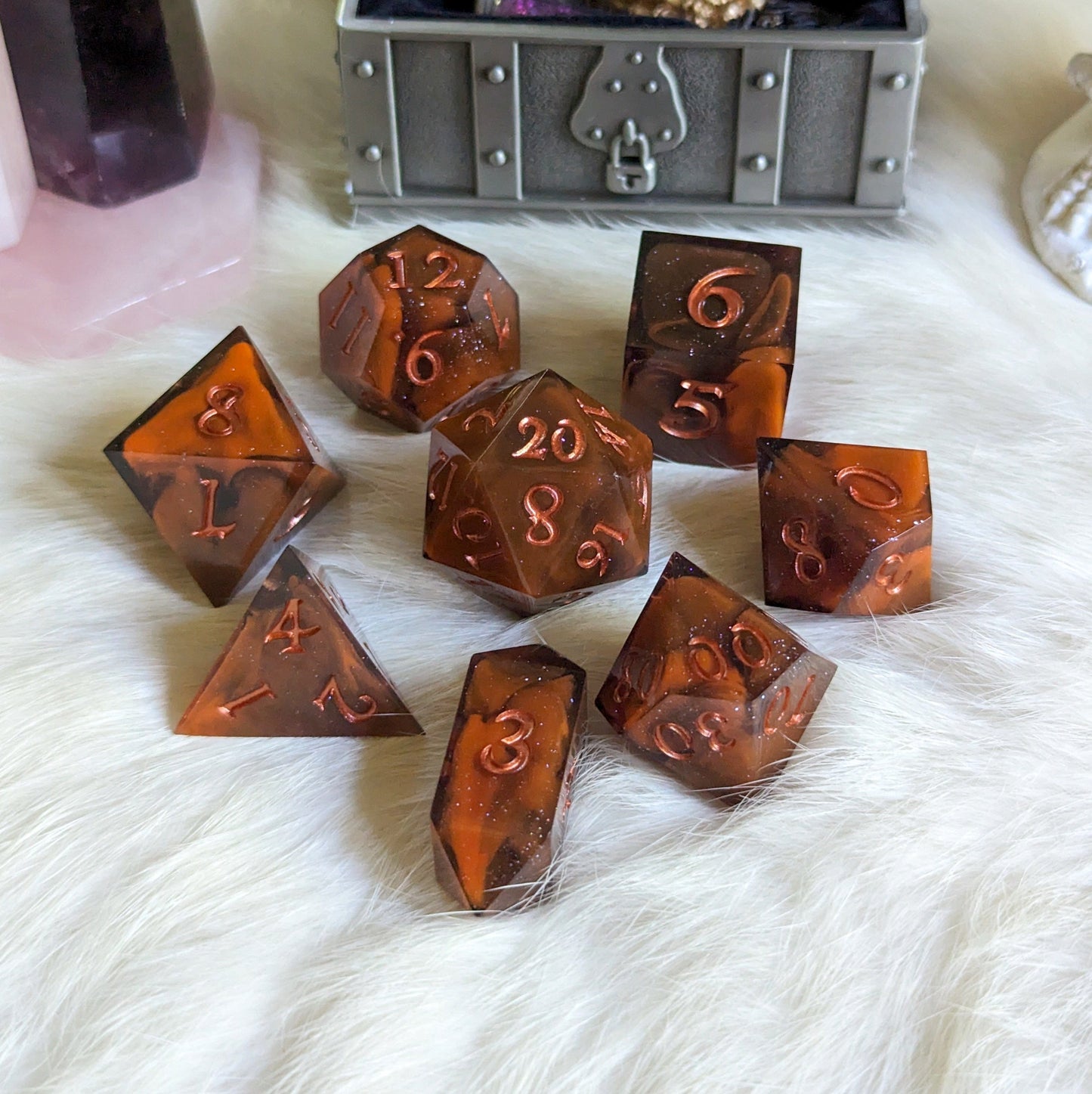 Shadow and Flame DnD dice set, orange and black marble with copper font, 7 piece TTRPG dice on a white background.
