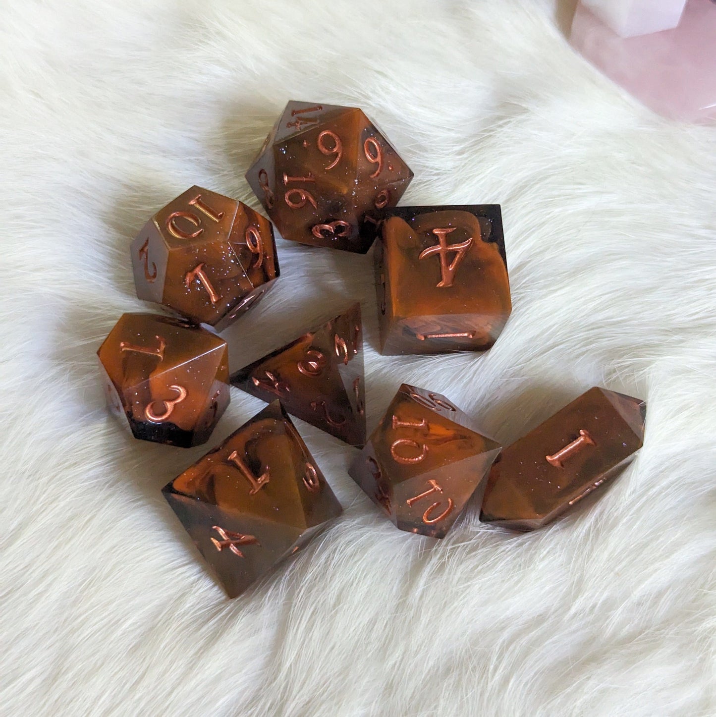Shadow and Flame DnD dice set featuring orange and black marble with copper font on white background, 7 unique hand-poured pieces.