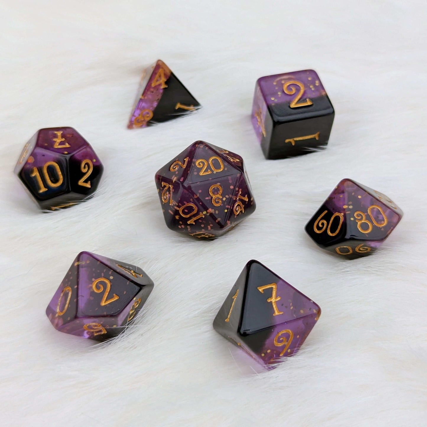 Shadow Magic Dice Set, 7-piece layered purple and black dice with gold glitter and font, on white background.