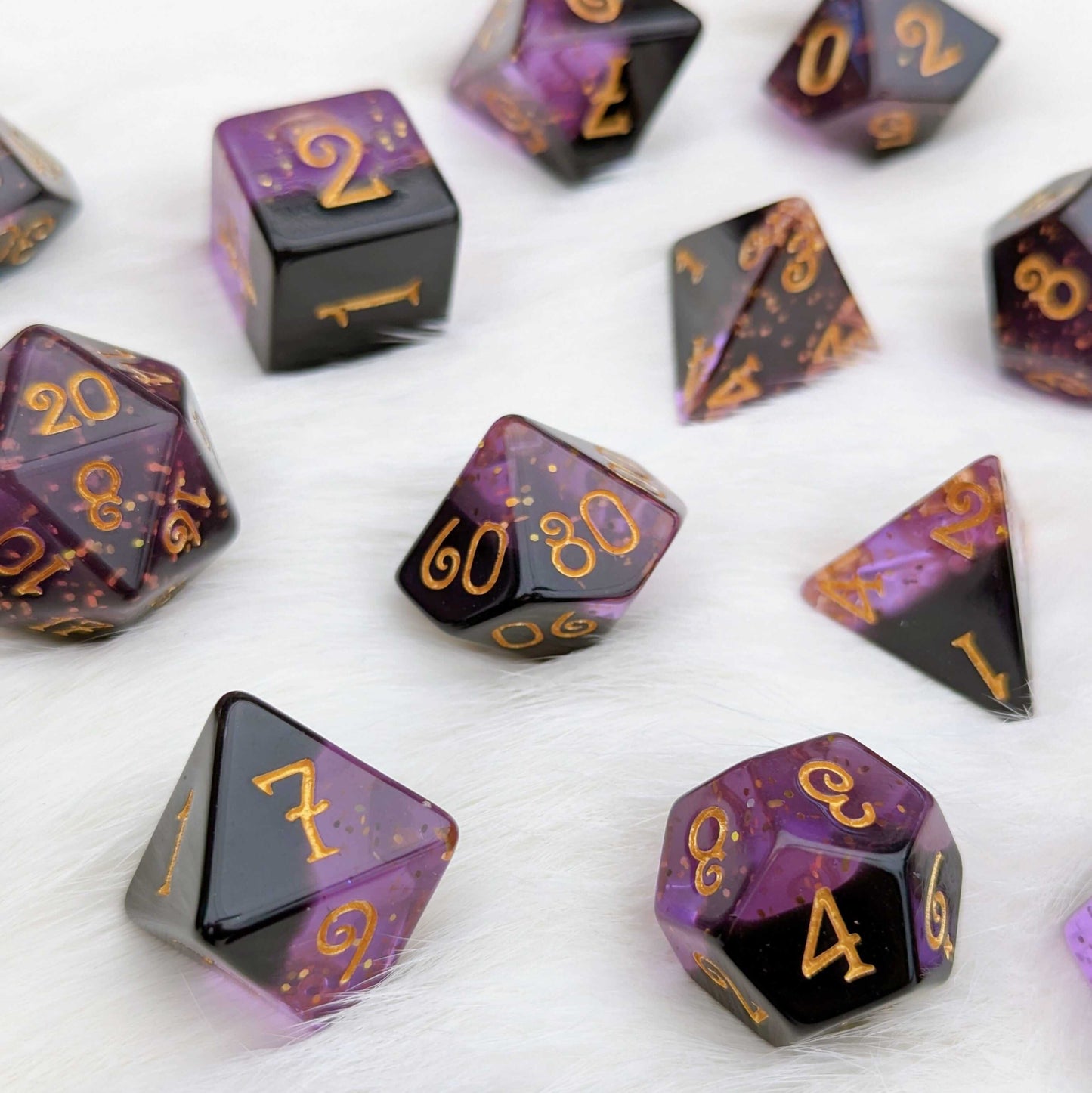 Shadow Magic Dice Set, 7-piece layered purple and black dice with gold glitter and numbers, exclusive design on white background.