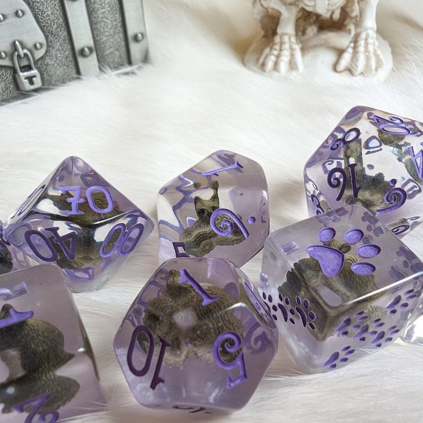 Sleepy Cat Dice Set with miniature cats inside clear resin, purple numbers, and paw counters, designed for tabletop RPGs.