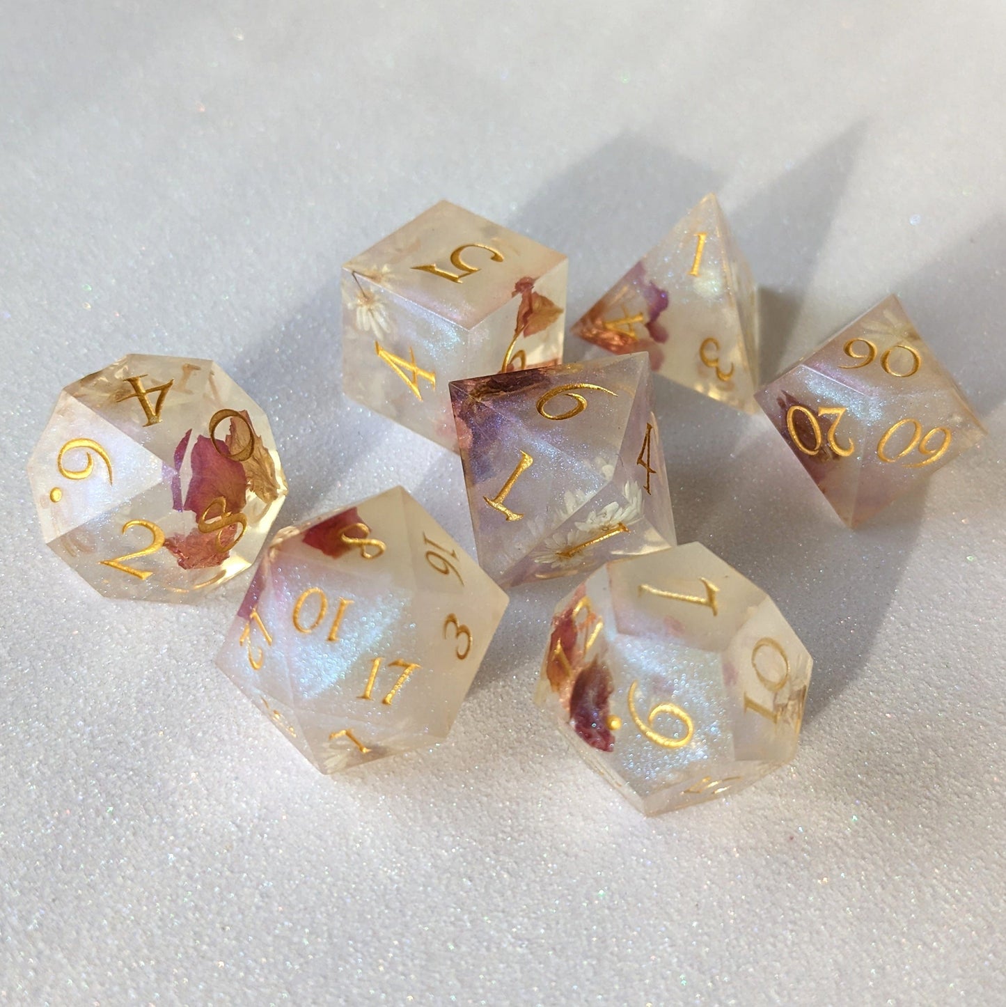 Sharp edge resin dice set with daisy flowers and rose petals in misty purple blue shimmer, perfect for D20 tabletop games.