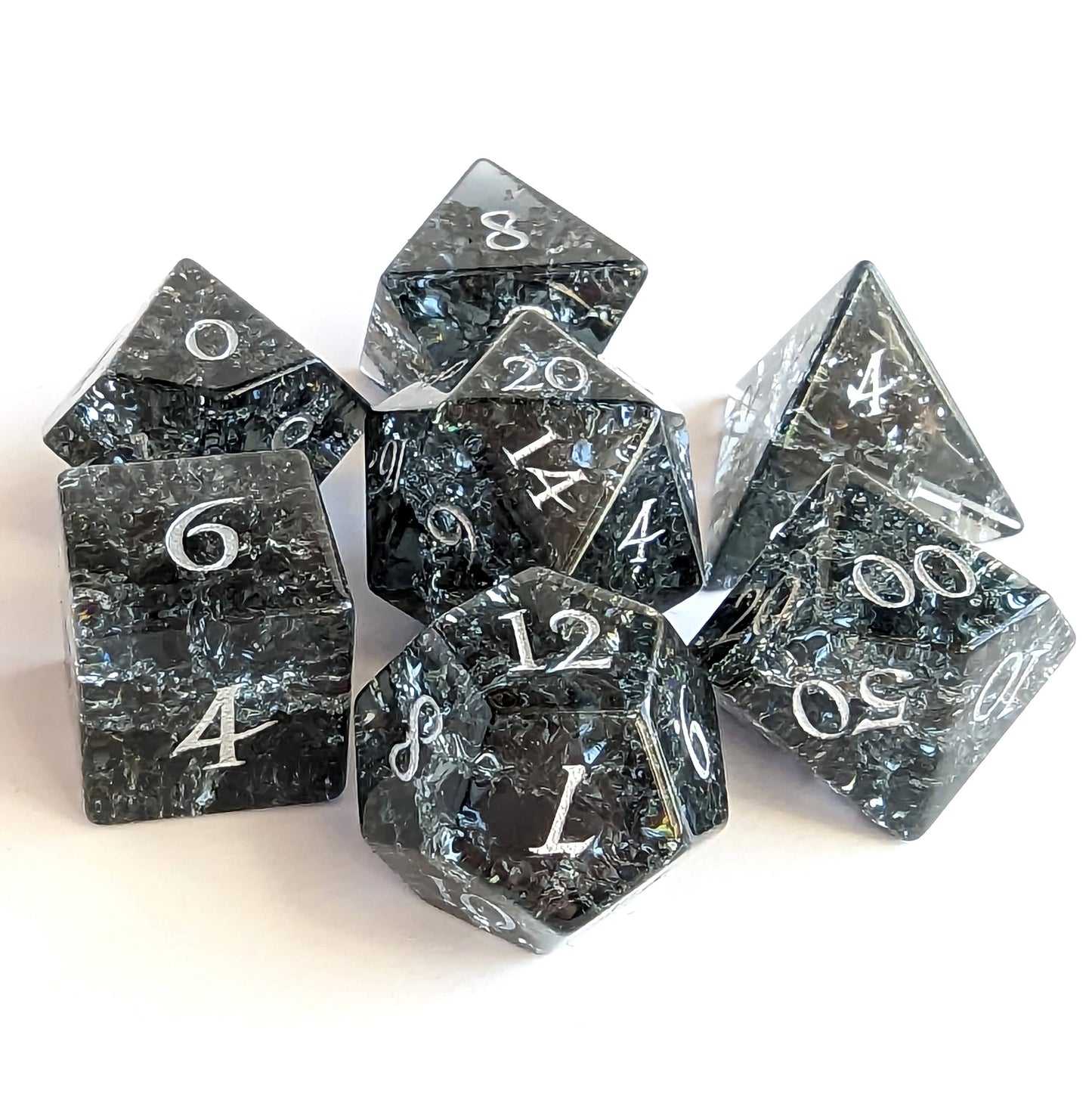 Black and blue crackled glass dice set for DnD gaming, includes d20, d12, d10, and more, perfect for tabletop RPG sessions.