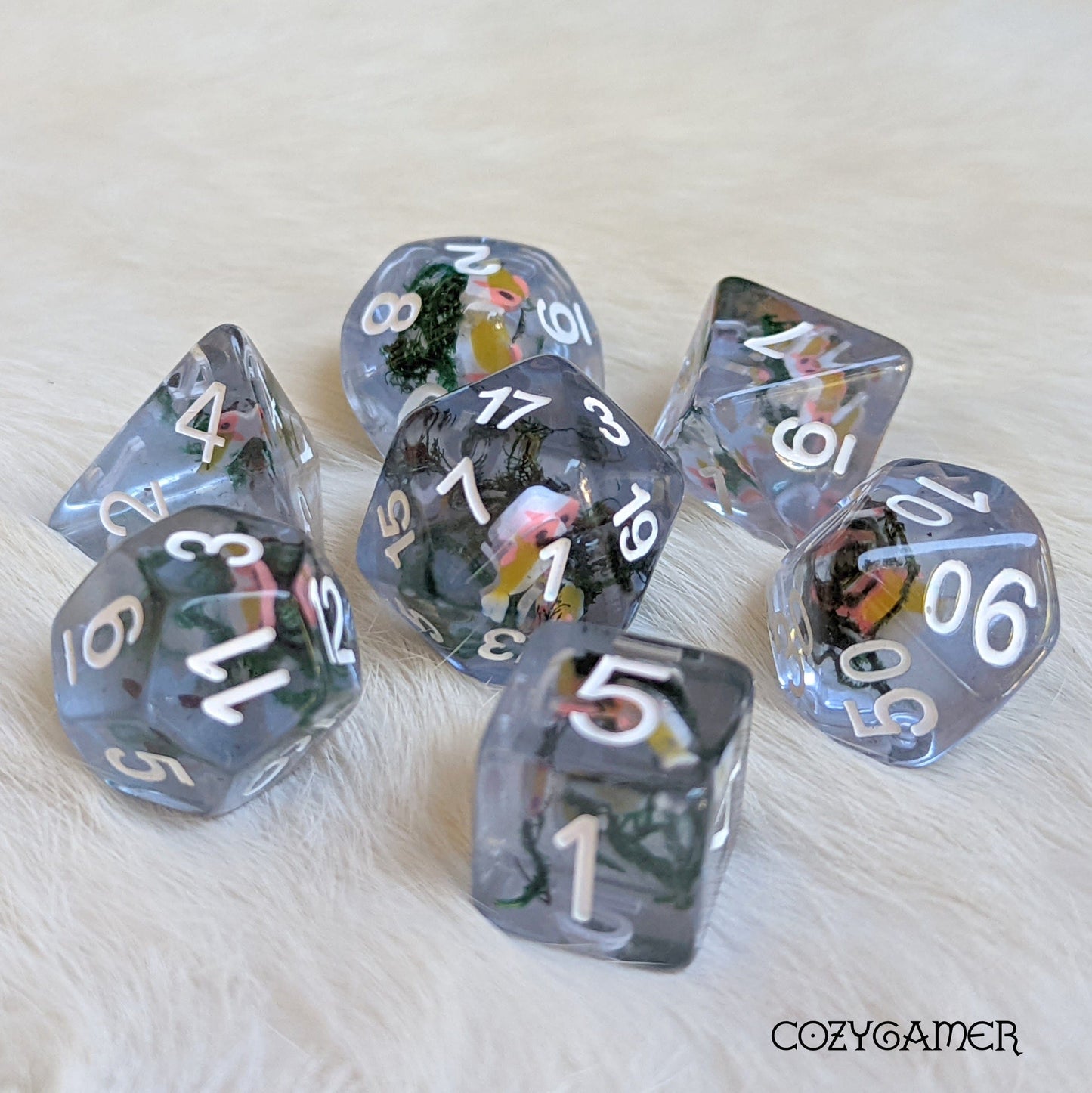 Blue Swimming Fish DnD dice set with clear resin, featuring tiny fish and dried moss, perfect for tabletop games like Dungeons and Dragons.