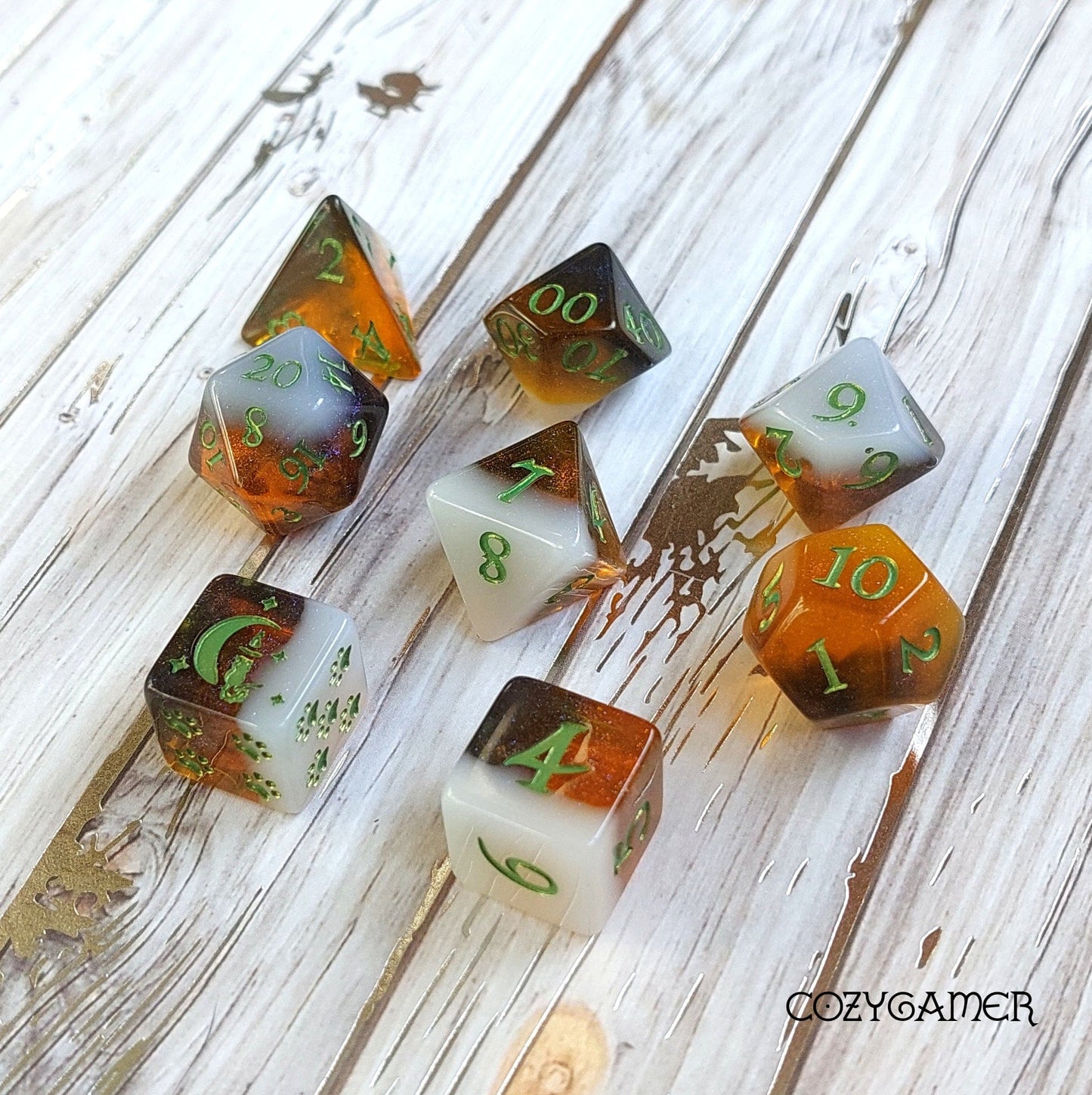 Calico Hazy IPA Dice Set, beer-themed DND dice in calico cat colors on wooden background, 8-piece set with green numbers.
