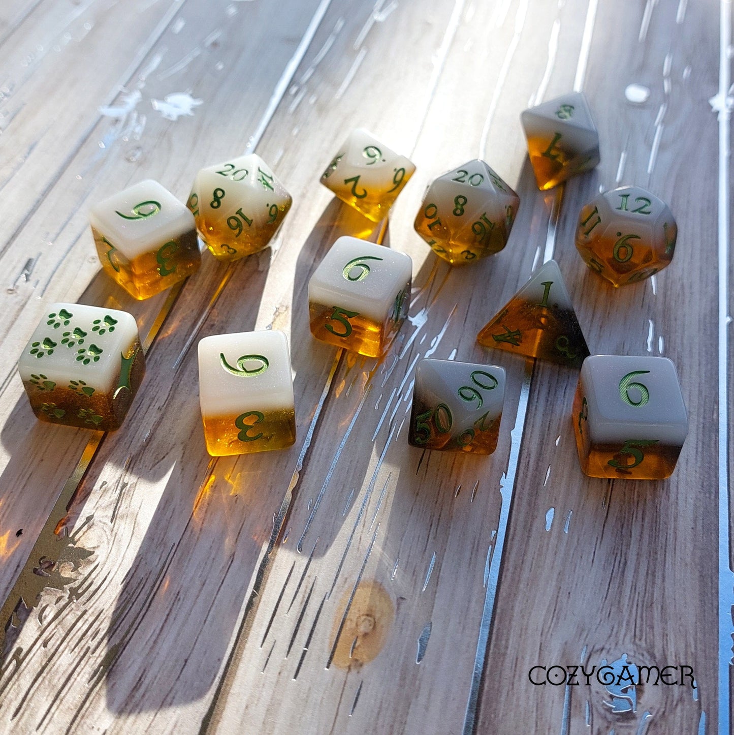 Calico Hazy IPA Dice Set in cat colors, featuring a 12-piece collection with unique beer-themed DND dice on a wooden table.
