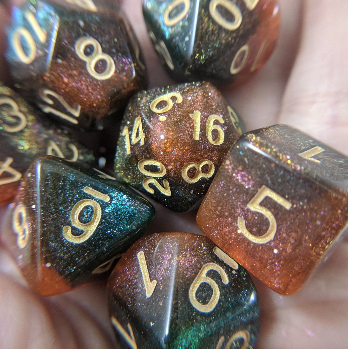 Carina Nebula Dice Set with orange and green marbled shimmer, ideal for Dungeons and Dragons or Magic The Gathering games.
