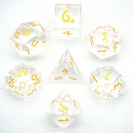 Clear glass TTRPG dice set with gold numbers, 7 gemstone pieces arranged on white background. Ideal for tabletop role-playing games.